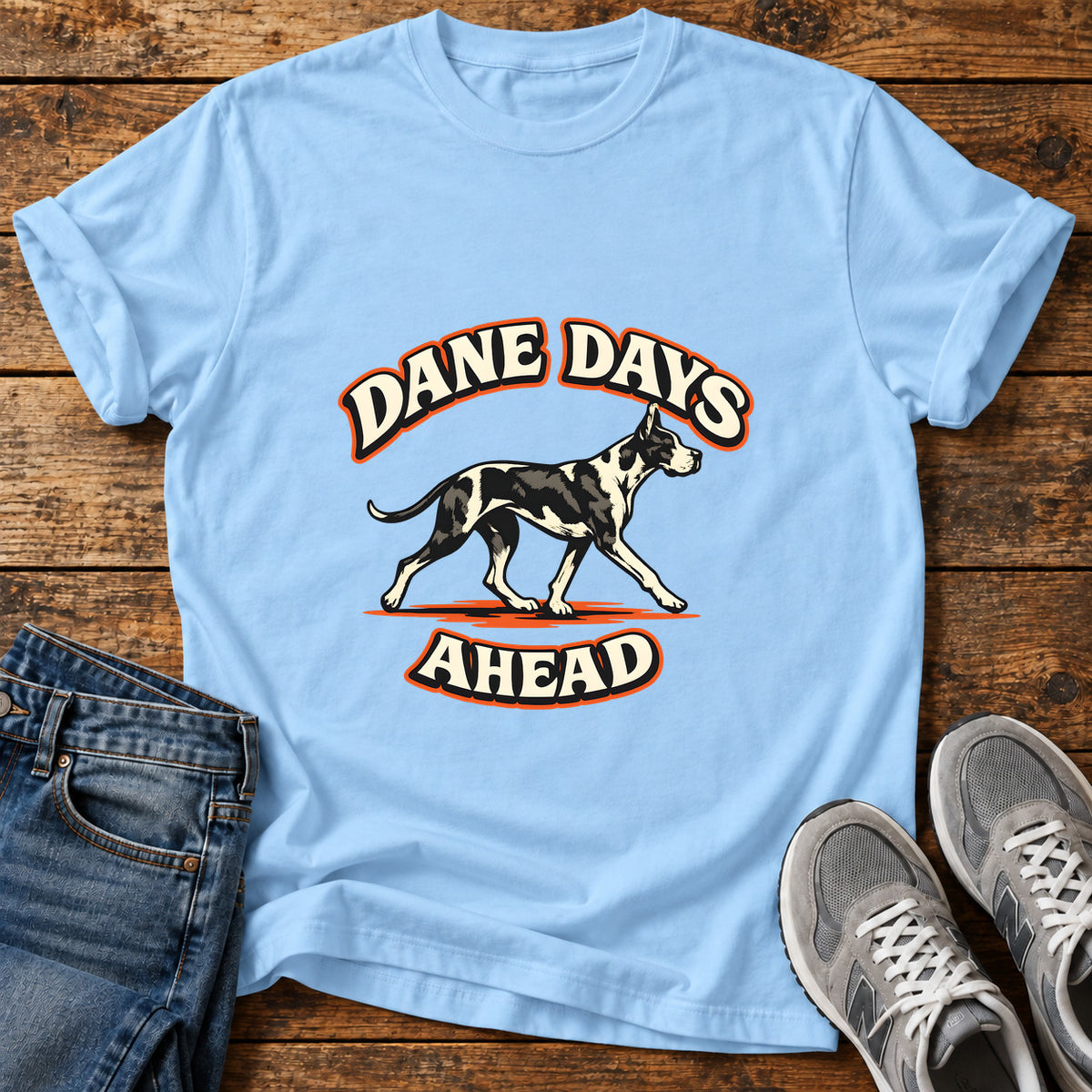 Dane Days Ahead Great Dane graphic T-shirt in Light Blue, shown on a flat-lay shirt mockup