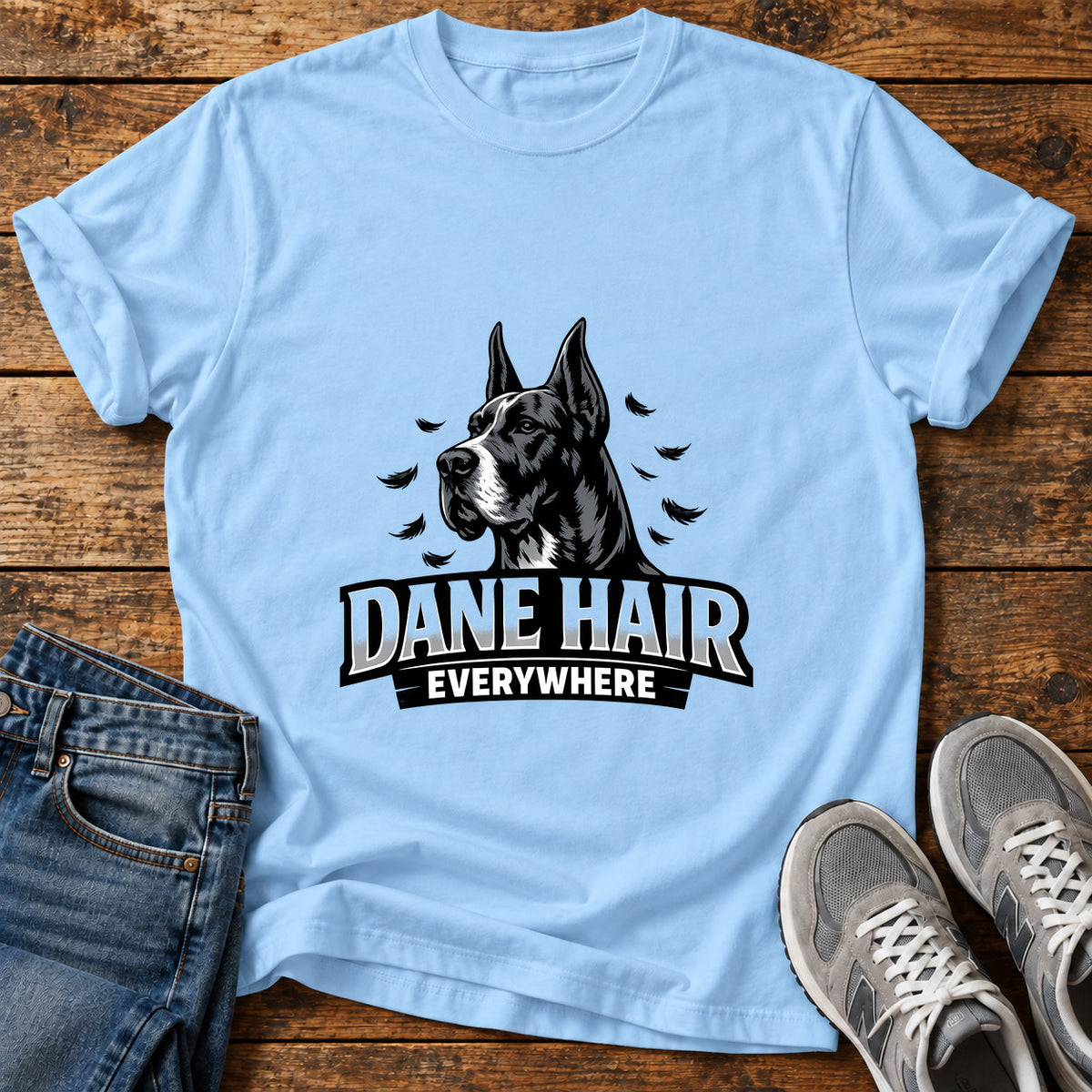 Dane Hair Everywhere Great Dane graphic T-shirt in Light Blue, shown on a flat-lay shirt mockup