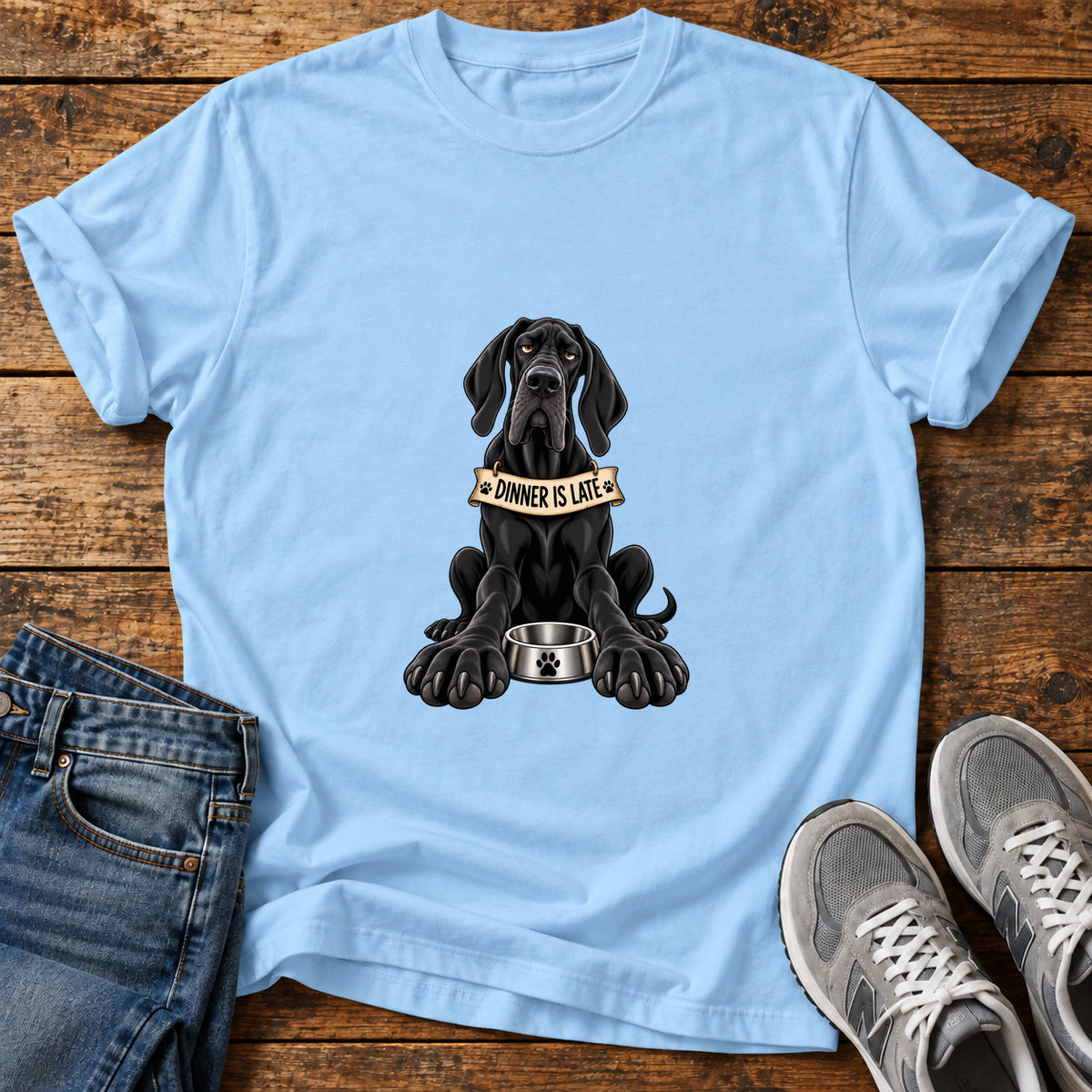 Dinner Is Late Great Dane graphic T-shirt in Light Blue, shown on a flat-lay shirt mockup