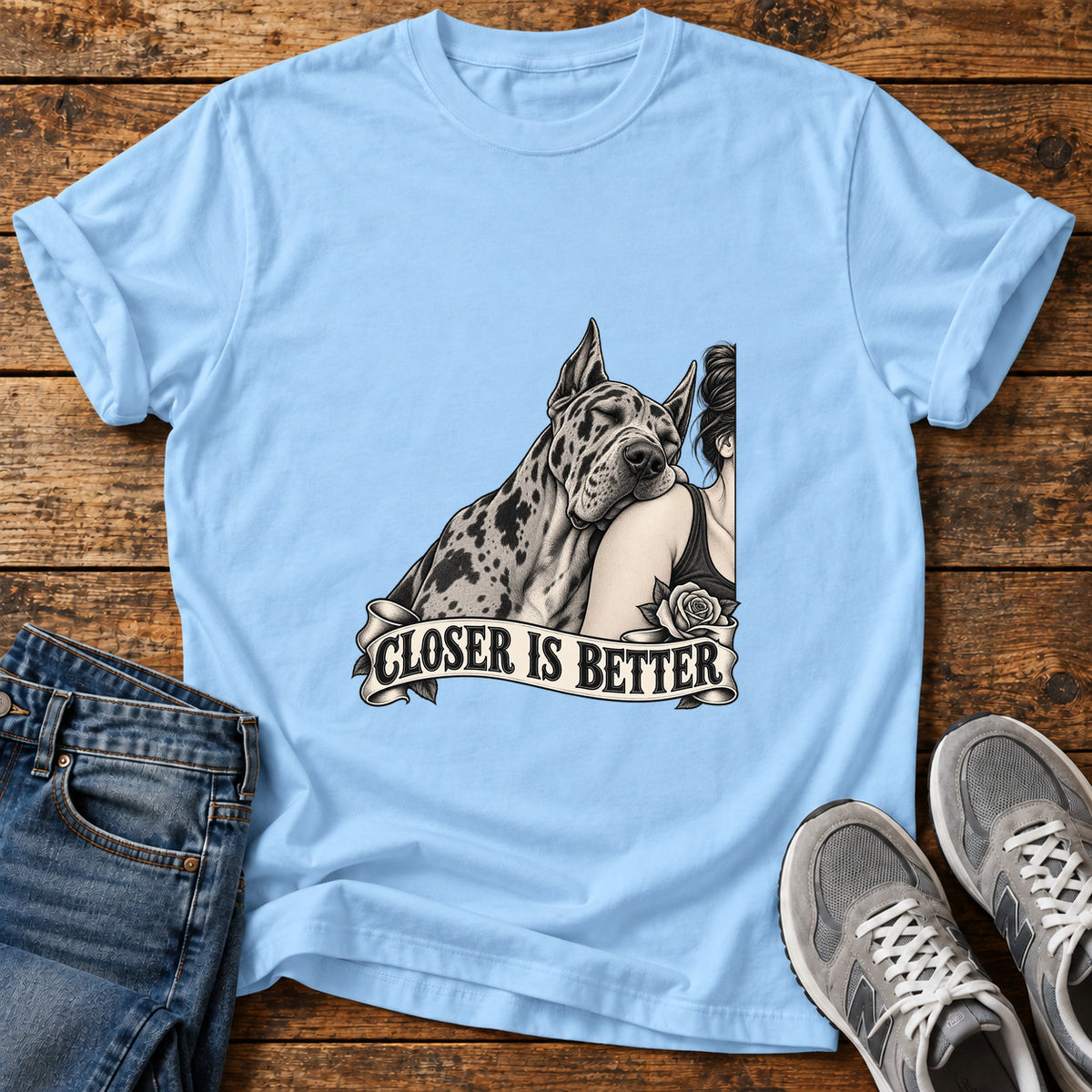 Closer Is Better Great Dane graphic T-shirt in Light Blue, shown on a flat-lay shirt mockup