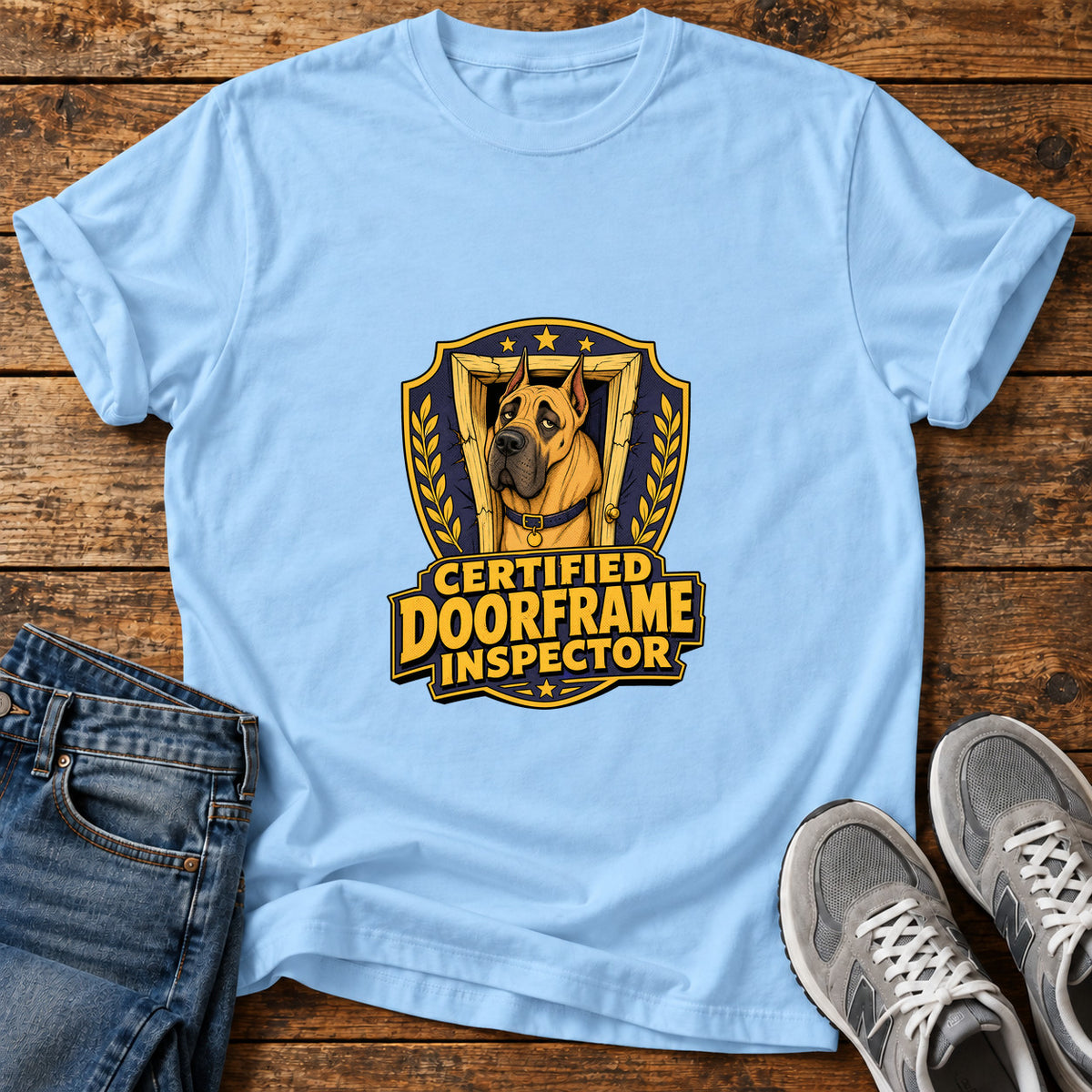 Certified Doorframe Inspector Great Dane graphic T-shirt in Light Blue, shown on a flat-lay shirt mockup