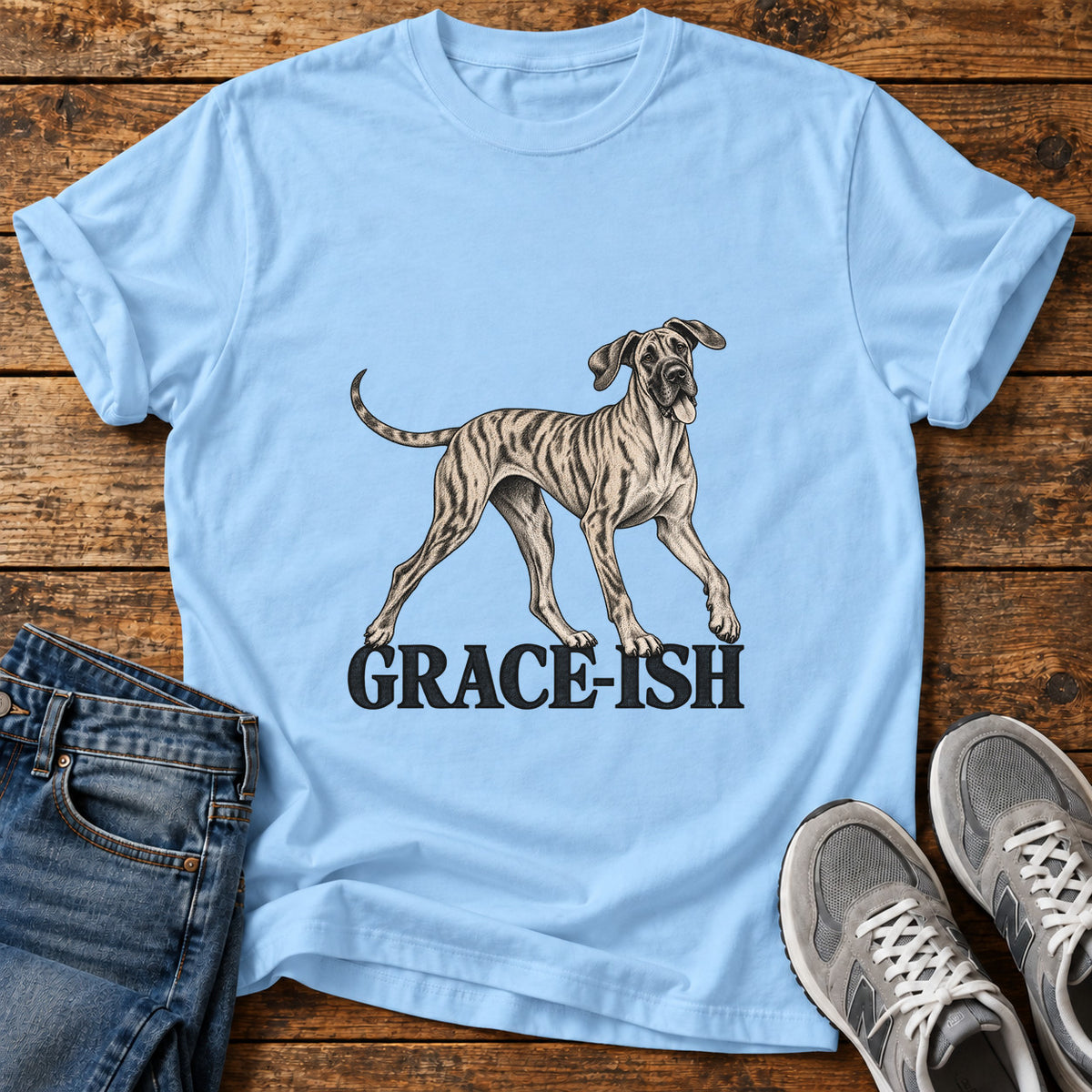 Grace-Ish Dog Great Dane graphic T-shirt in Light Blue, shown on a flat-lay shirt mockup