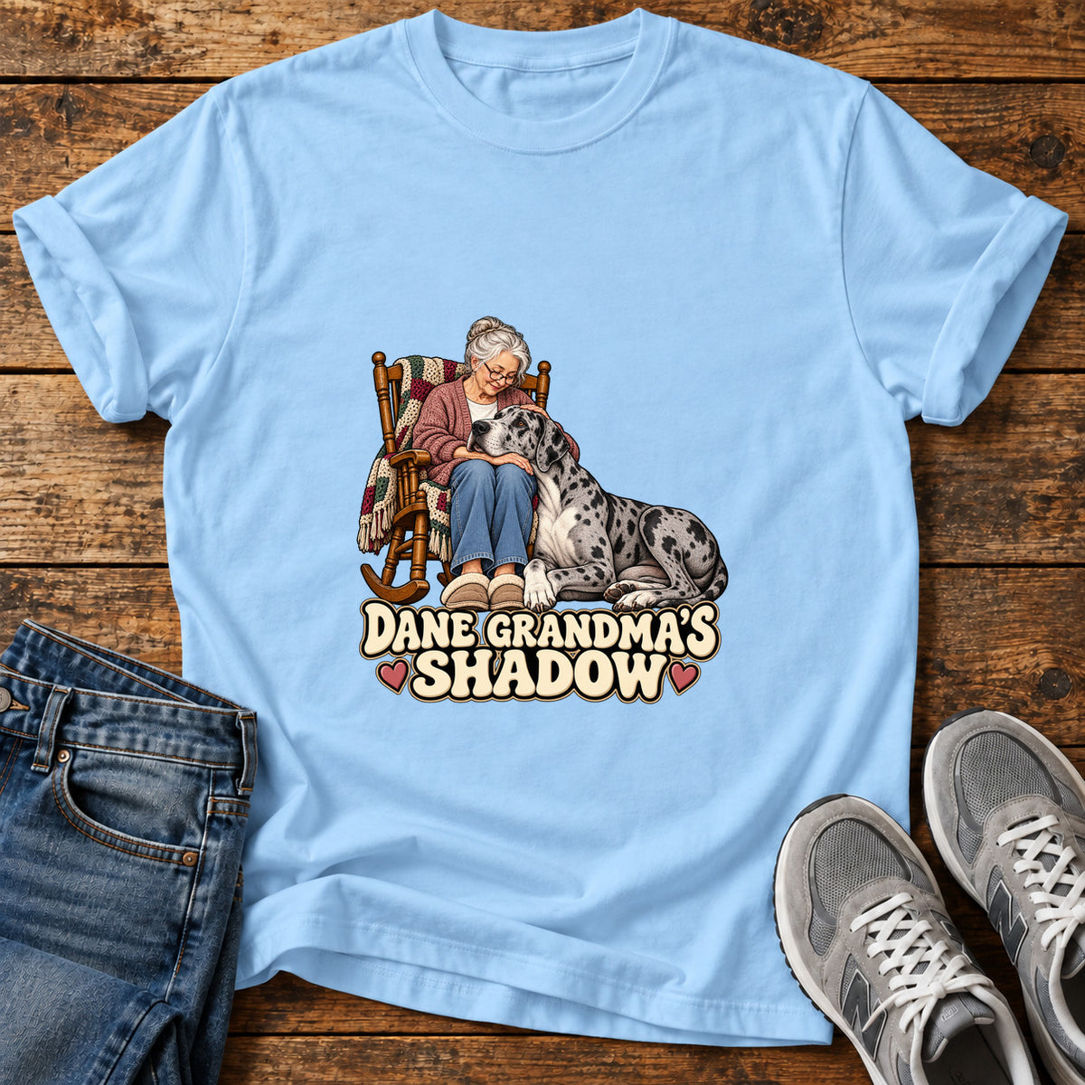 Dane Grandma's Shadow Great Dane graphic T-shirt in Light Blue, shown on a flat-lay shirt mockup