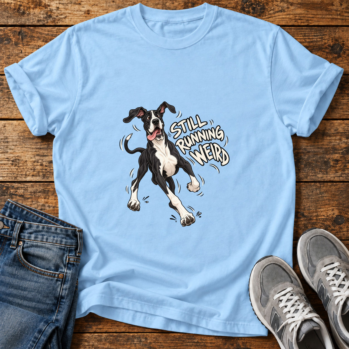 Running Weird Great Dane graphic T-shirt in Light Blue, shown on a flat-lay shirt mockup