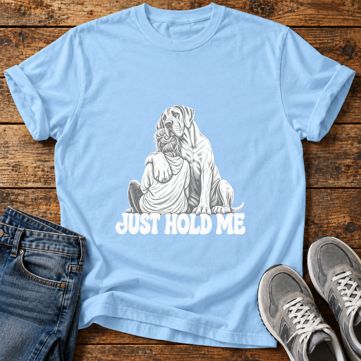 Just Hold Me Great Dane graphic T-shirt in Light Blue, shown on a flat-lay shirt mockup