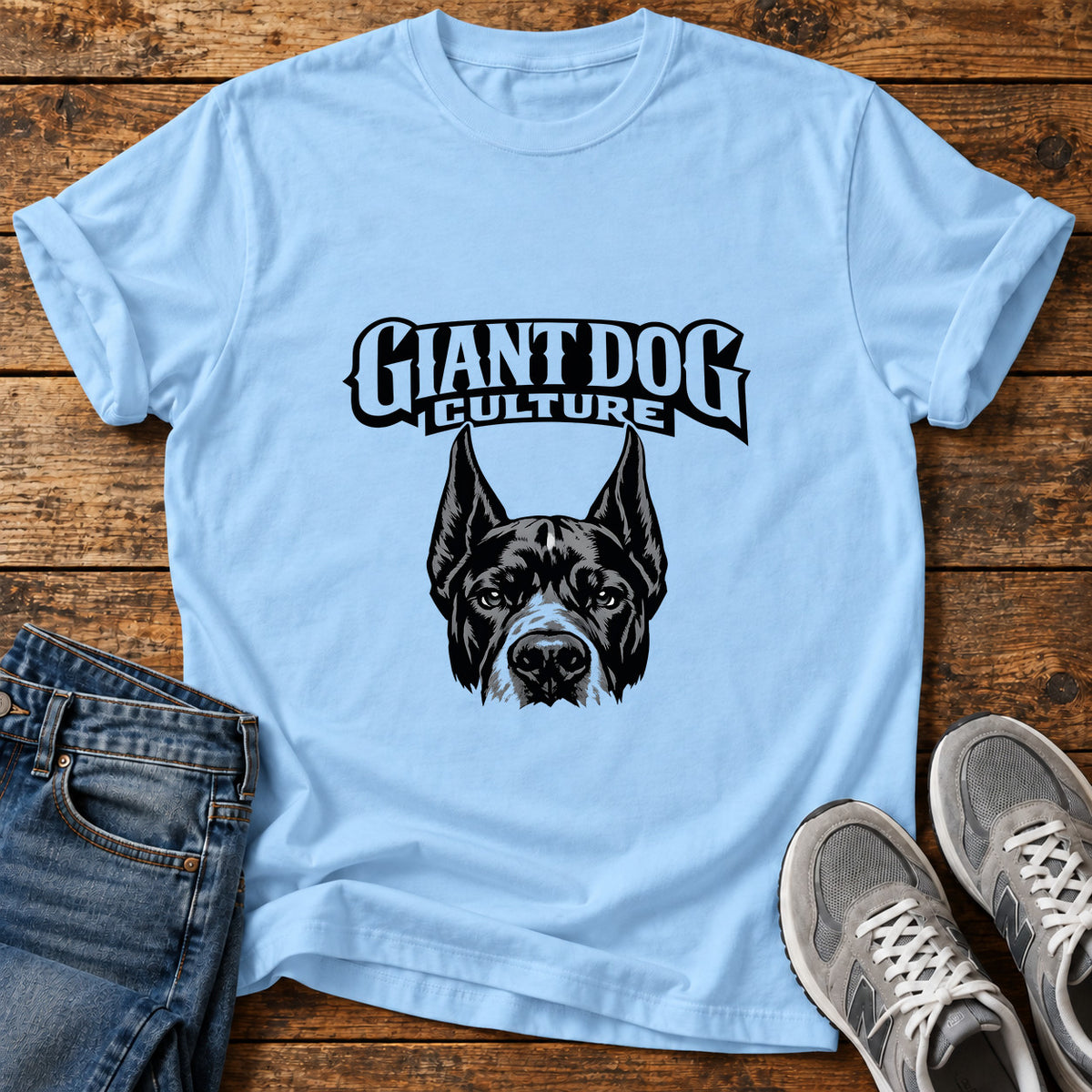 Giant Dog Culture Great Dane graphic T-shirt in Light Blue, shown on a flat-lay shirt mockup