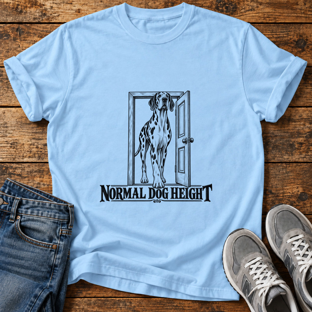 Normal Dog Height Great Dane graphic T-shirt in Light Blue, shown on a flat-lay shirt mockup