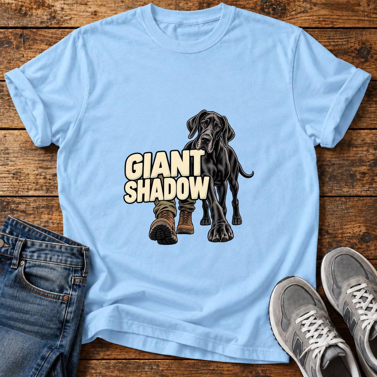 Giant Shadow Great Dane graphic T-shirt in Light Blue, shown on a flat-lay shirt mockup