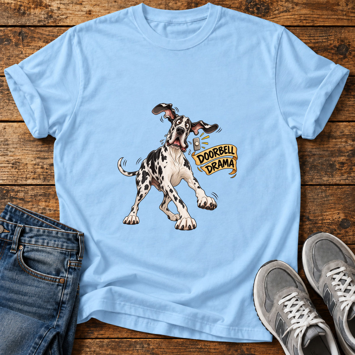 Doorbell Drama Great Dane graphic T-shirt in Light Blue, shown on a flat-lay shirt mockup