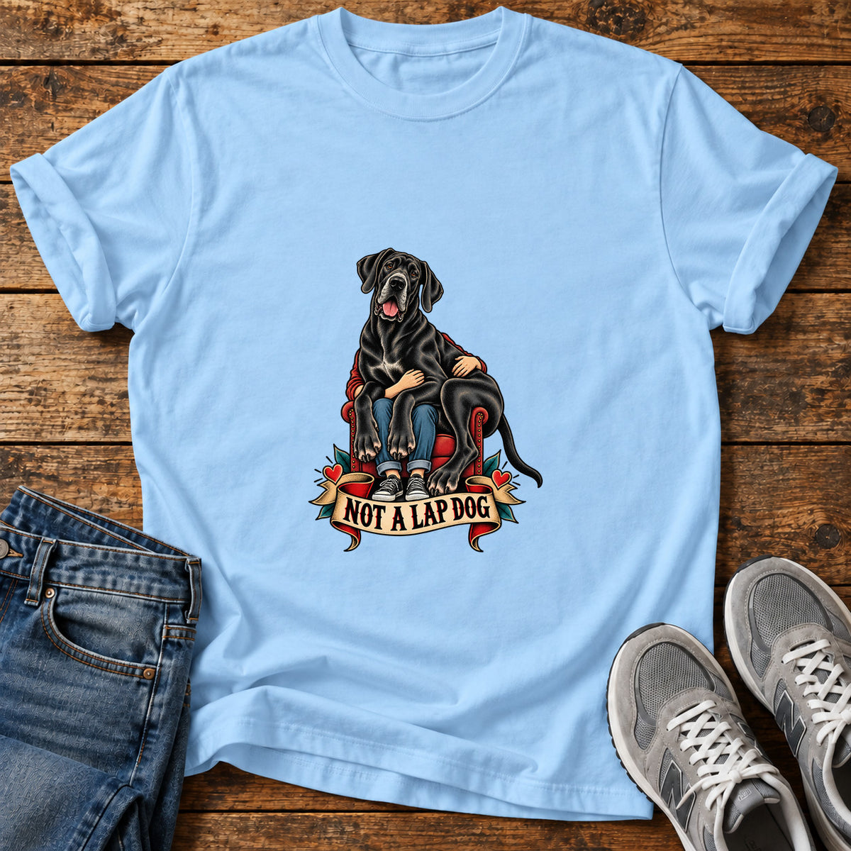 Not A Lapdog Great Dane graphic T-shirt in Light Blue, shown on a flat-lay shirt mockup