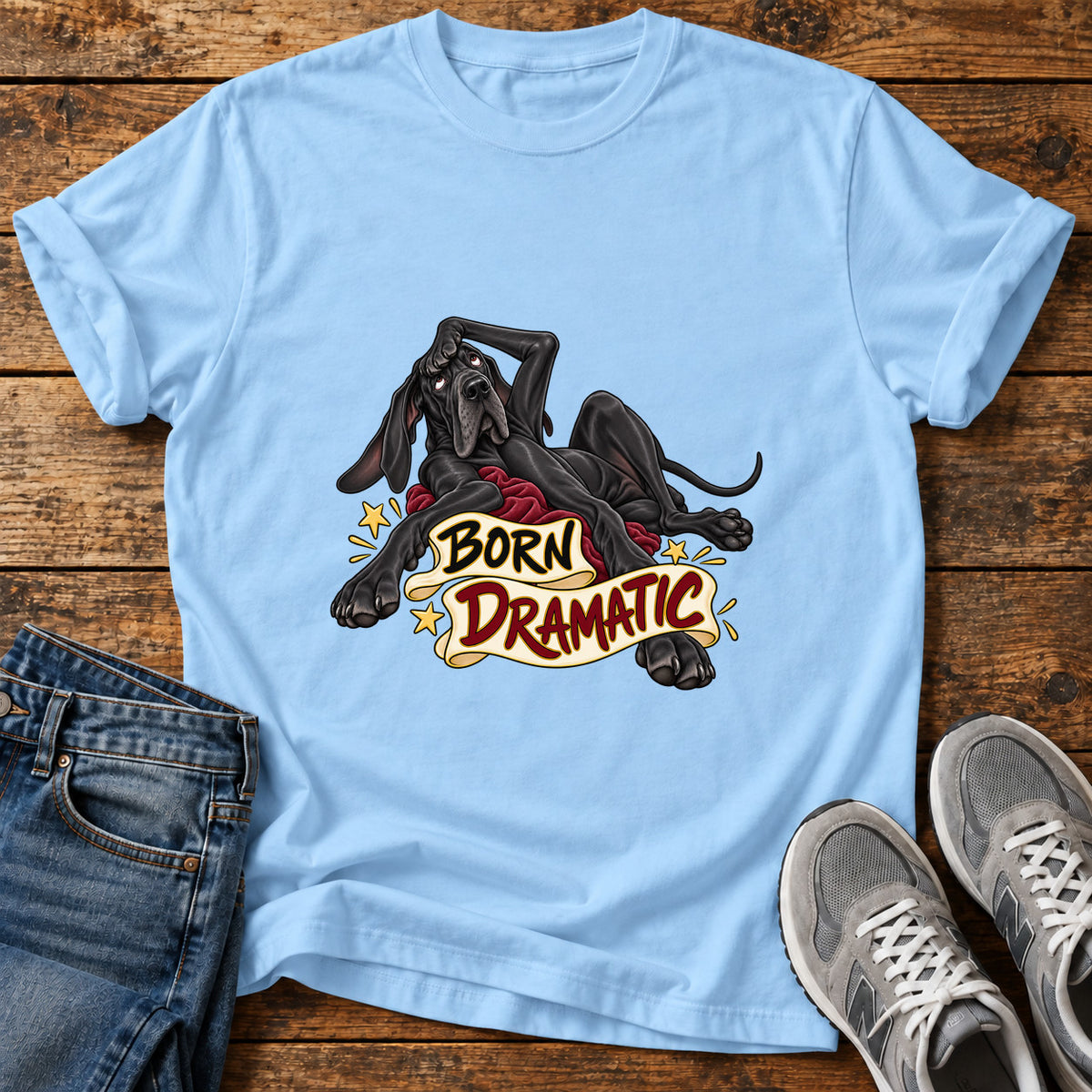 Born Dramatic Great Dane graphic T-shirt in Light Blue, shown on a flat-lay shirt mockup