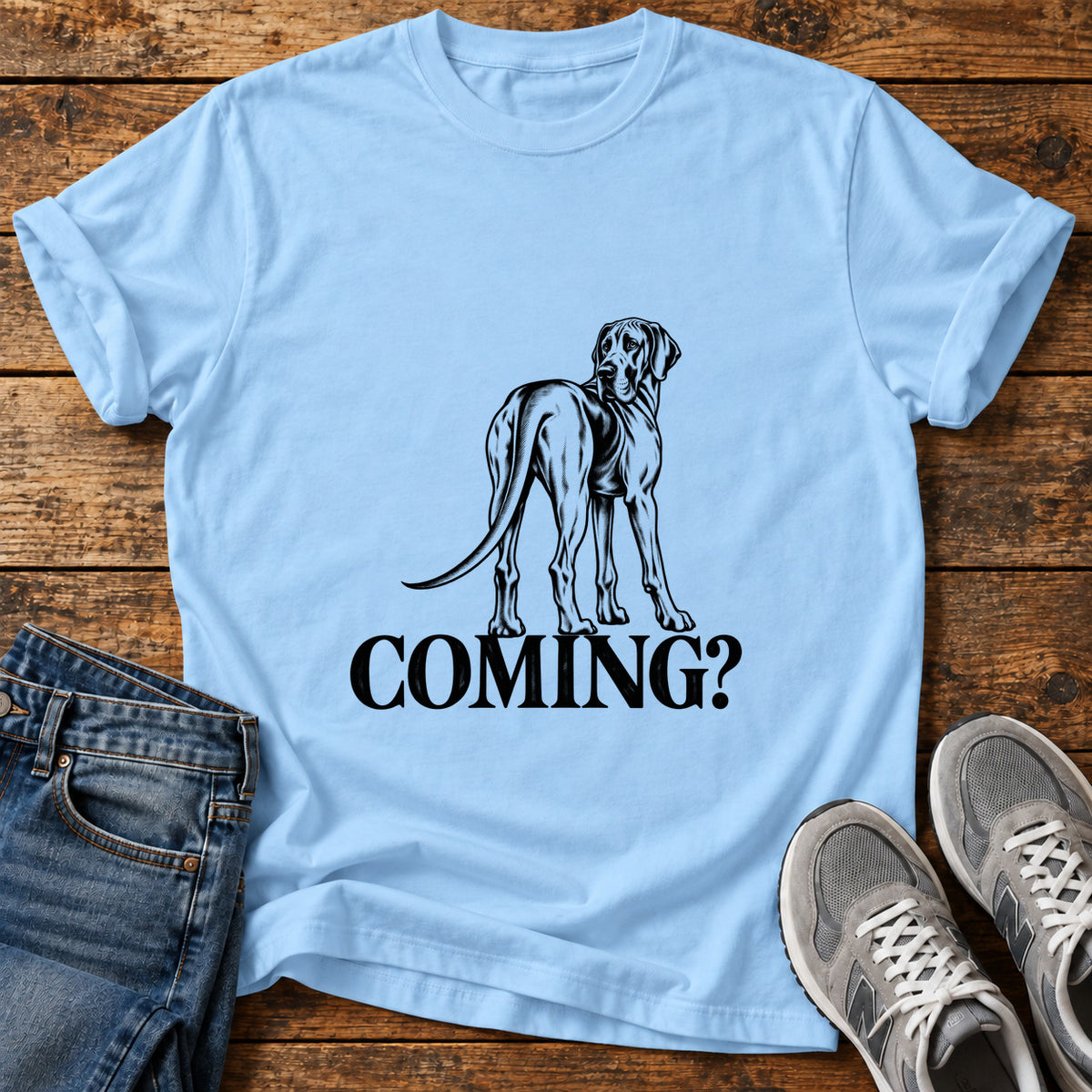 Coming Dog Great Dane graphic T-shirt in Light Blue, shown on a flat-lay shirt mockup
