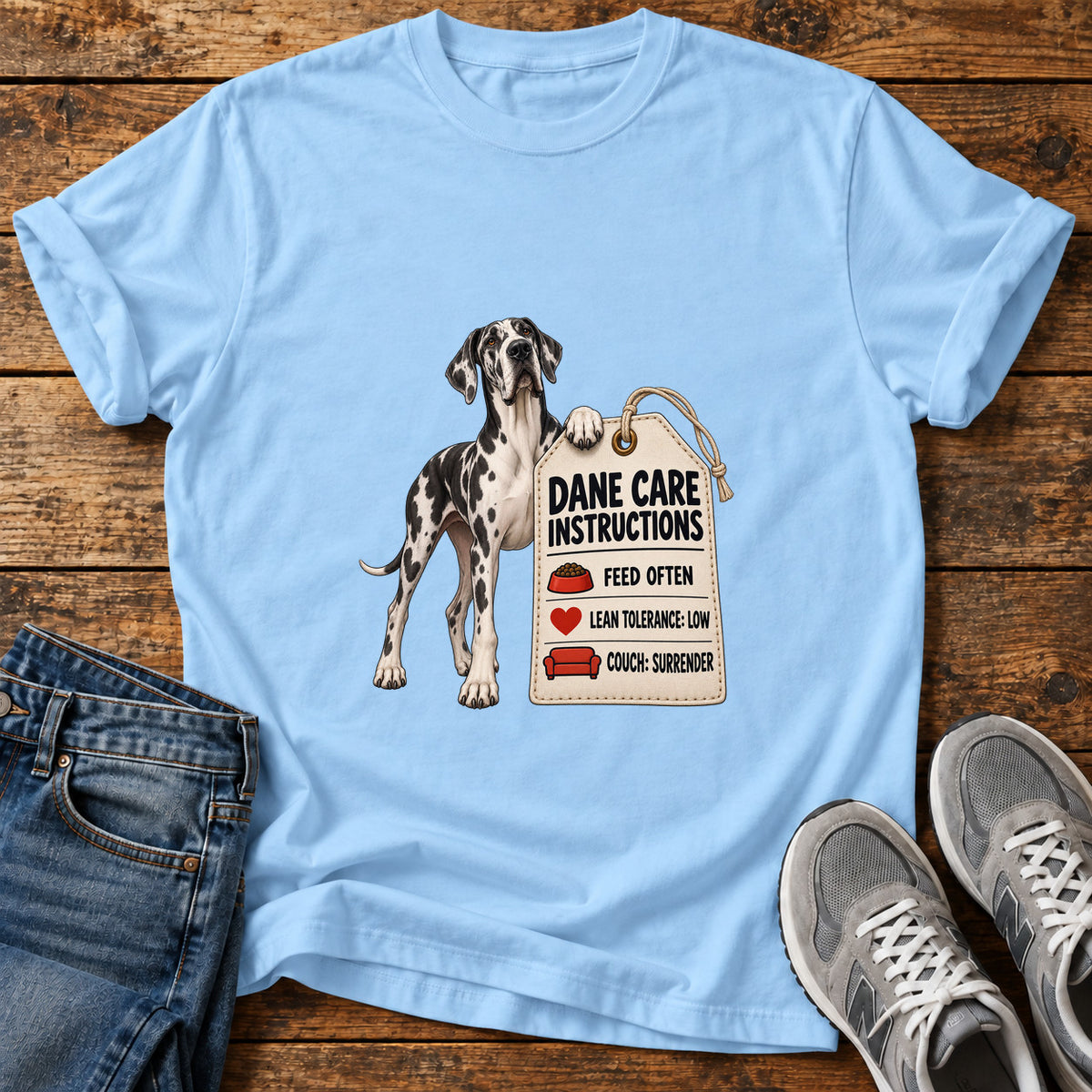Dane Care Guide Great Dane graphic T-shirt in Light Blue, shown on a flat-lay shirt mockup