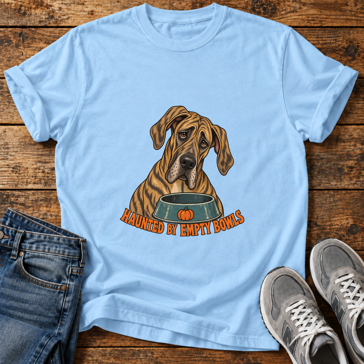 Haunted Bowls Great Dane graphic T-shirt in Light Blue, shown on a flat-lay shirt mockup