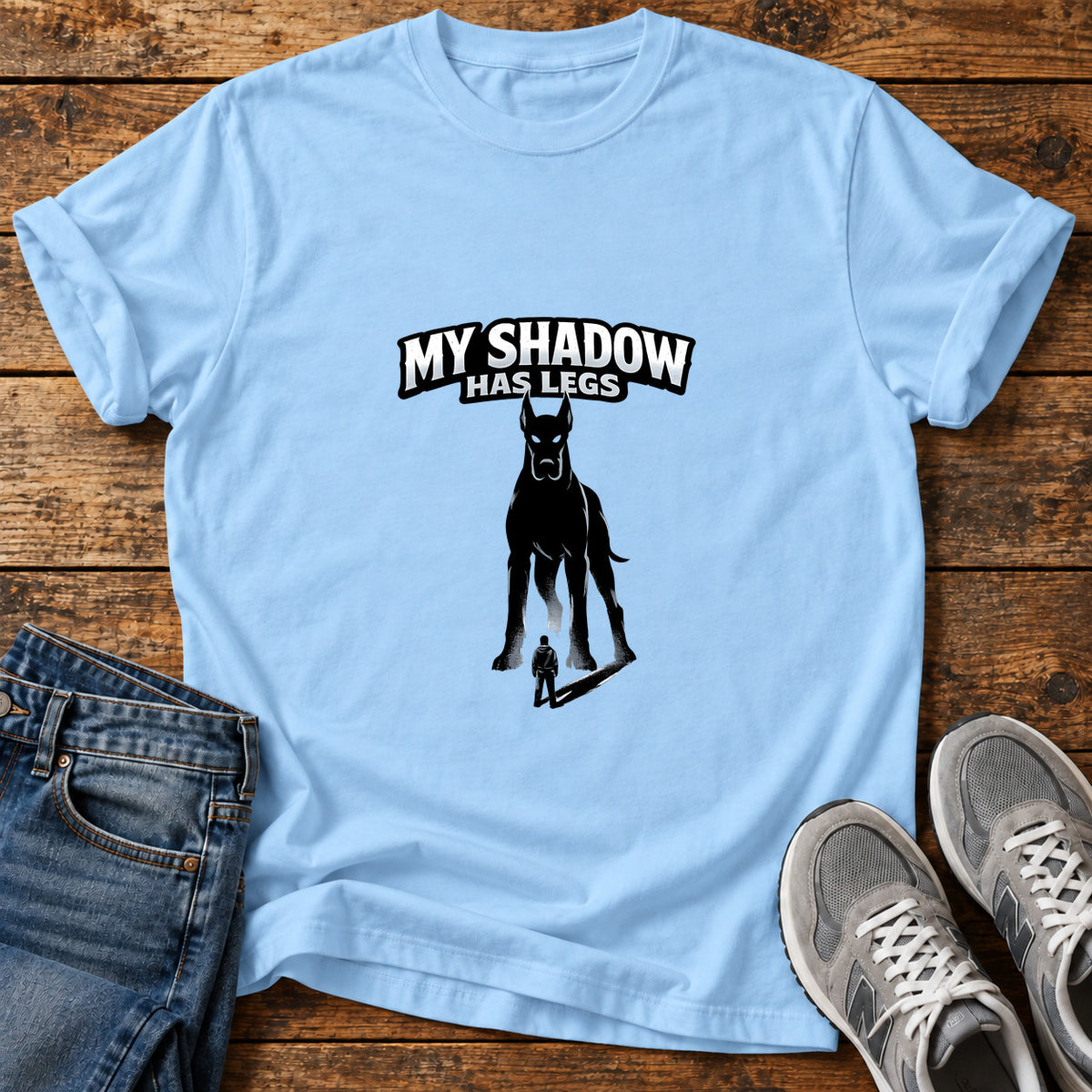 My Shadow Great Dane graphic T-shirt in Light Blue, shown on a flat-lay shirt mockup