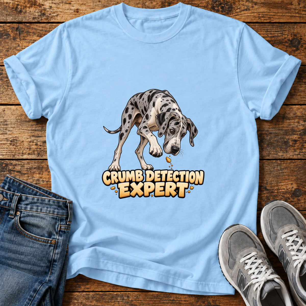 Crumb Detection Expert Great Dane graphic T-shirt in Light Blue, shown on a flat-lay shirt mockup