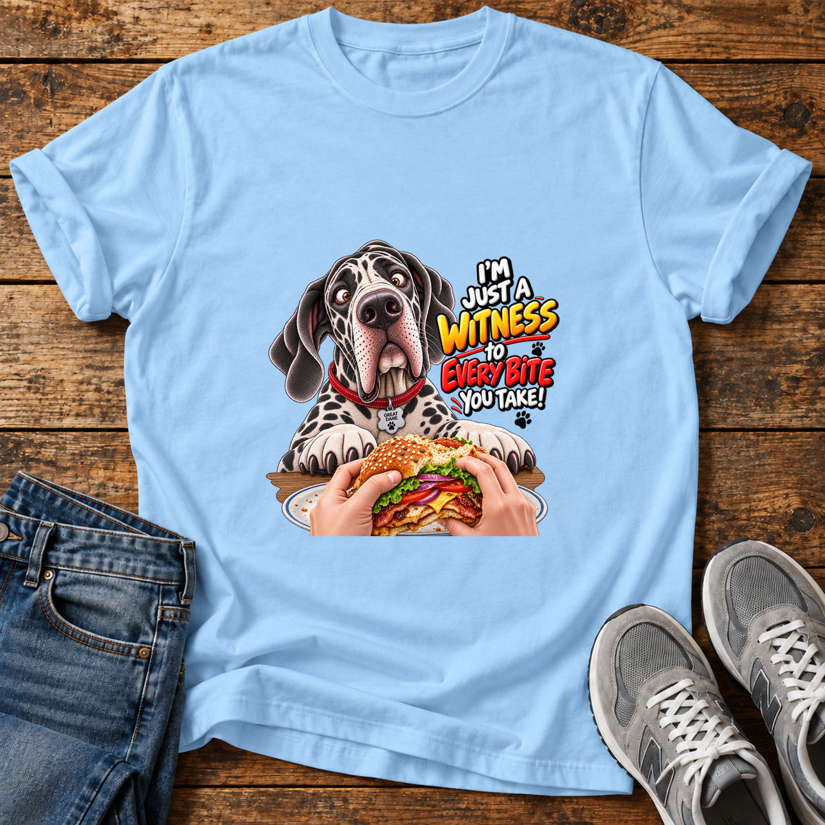 Witness Every Bite Great Dane graphic T-shirt in Light Blue, shown on a flat-lay shirt mockup
