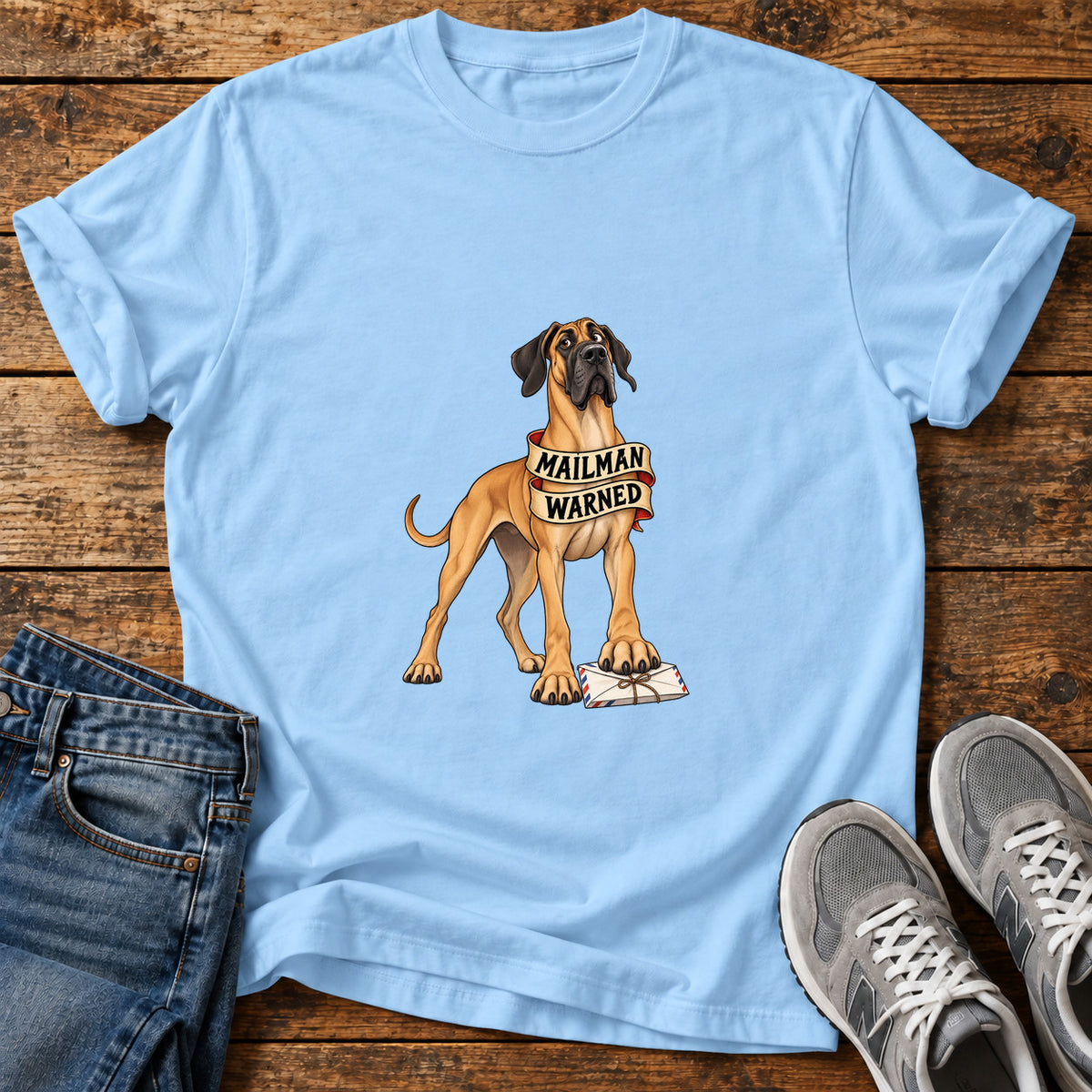 Mailman Warned Great Dane graphic T-shirt in Light Blue, shown on a flat-lay shirt mockup