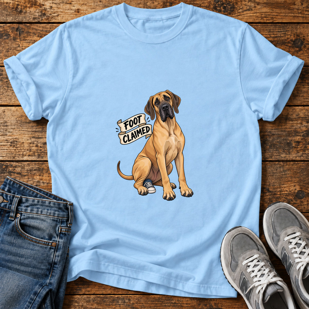 Foot Claimed Great Dane graphic T-shirt in Light Blue, shown on a flat-lay shirt mockup