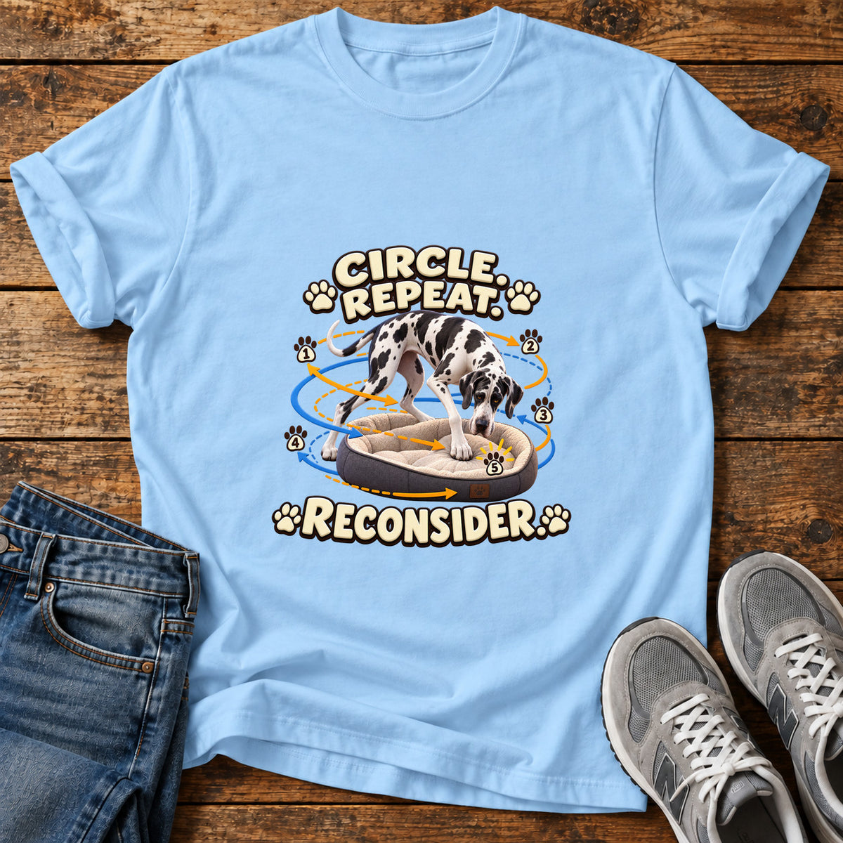 Circle Repeat Reconsider Great Dane graphic T-shirt in Light Blue, shown on a flat-lay shirt mockup