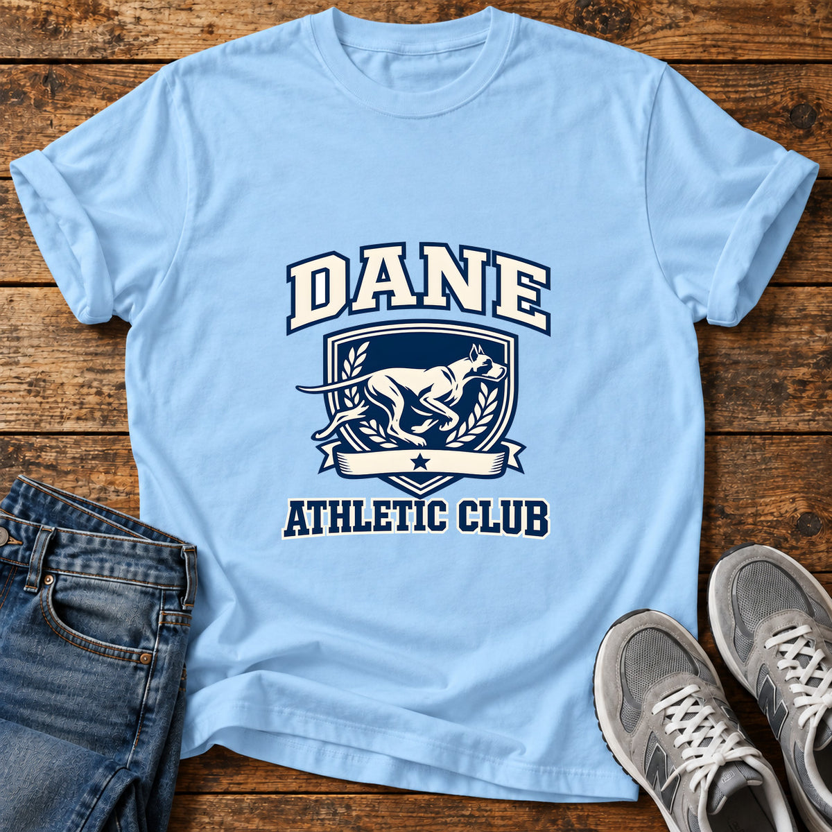 Dane Athletic Club Great Dane graphic T-shirt in Light Blue, shown on a flat-lay shirt mockup