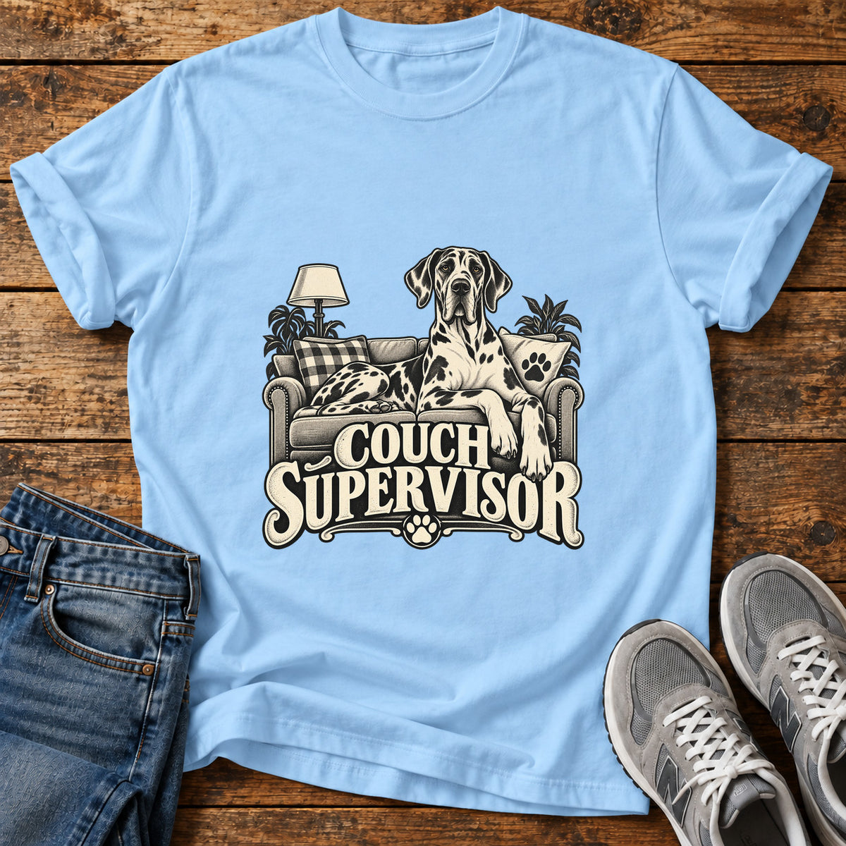 Couch Supervisor Great Dane graphic T-shirt in Light Blue, shown on a flat-lay shirt mockup