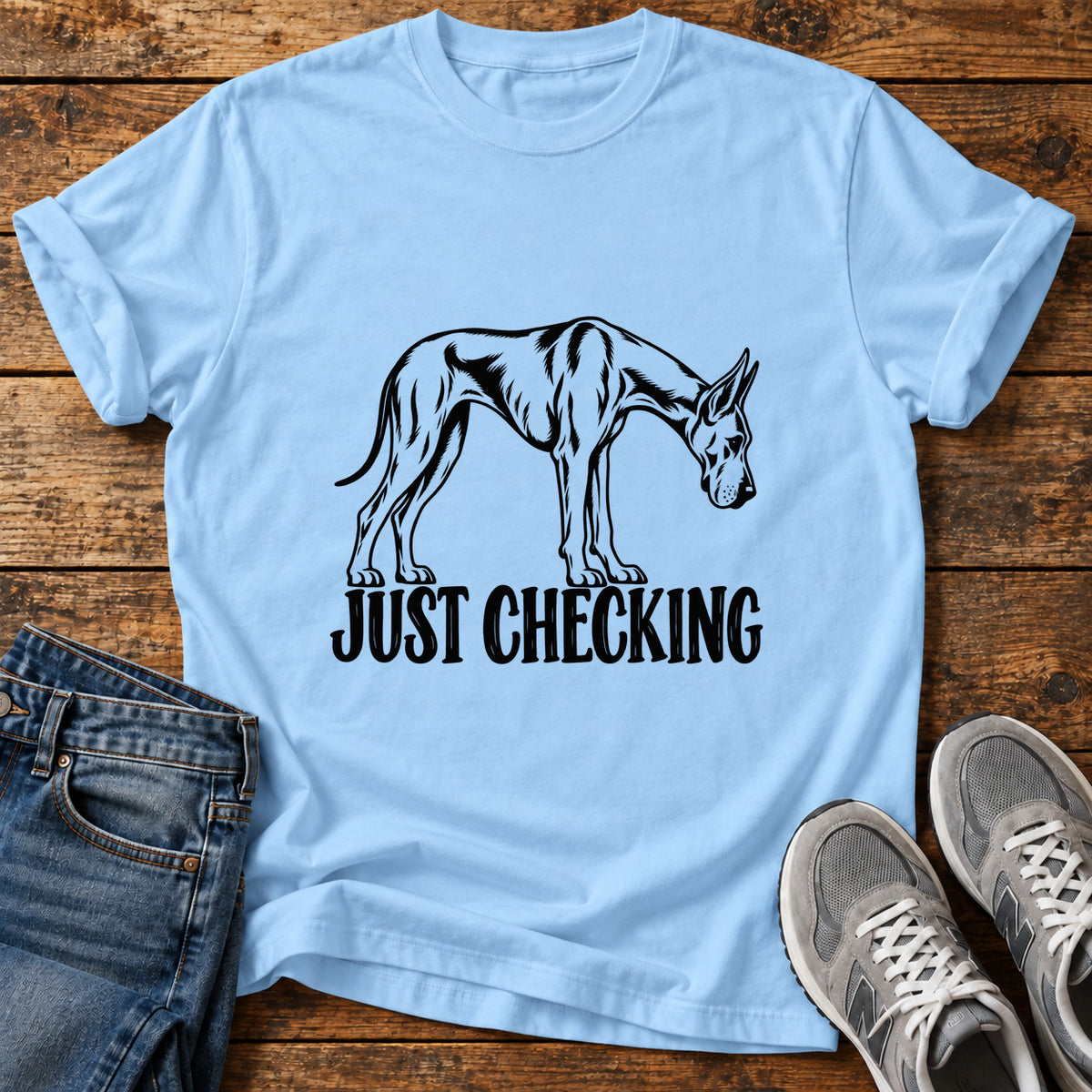 Just Checking Great Dane graphic T-shirt in Light Blue, shown on a flat-lay shirt mockup
