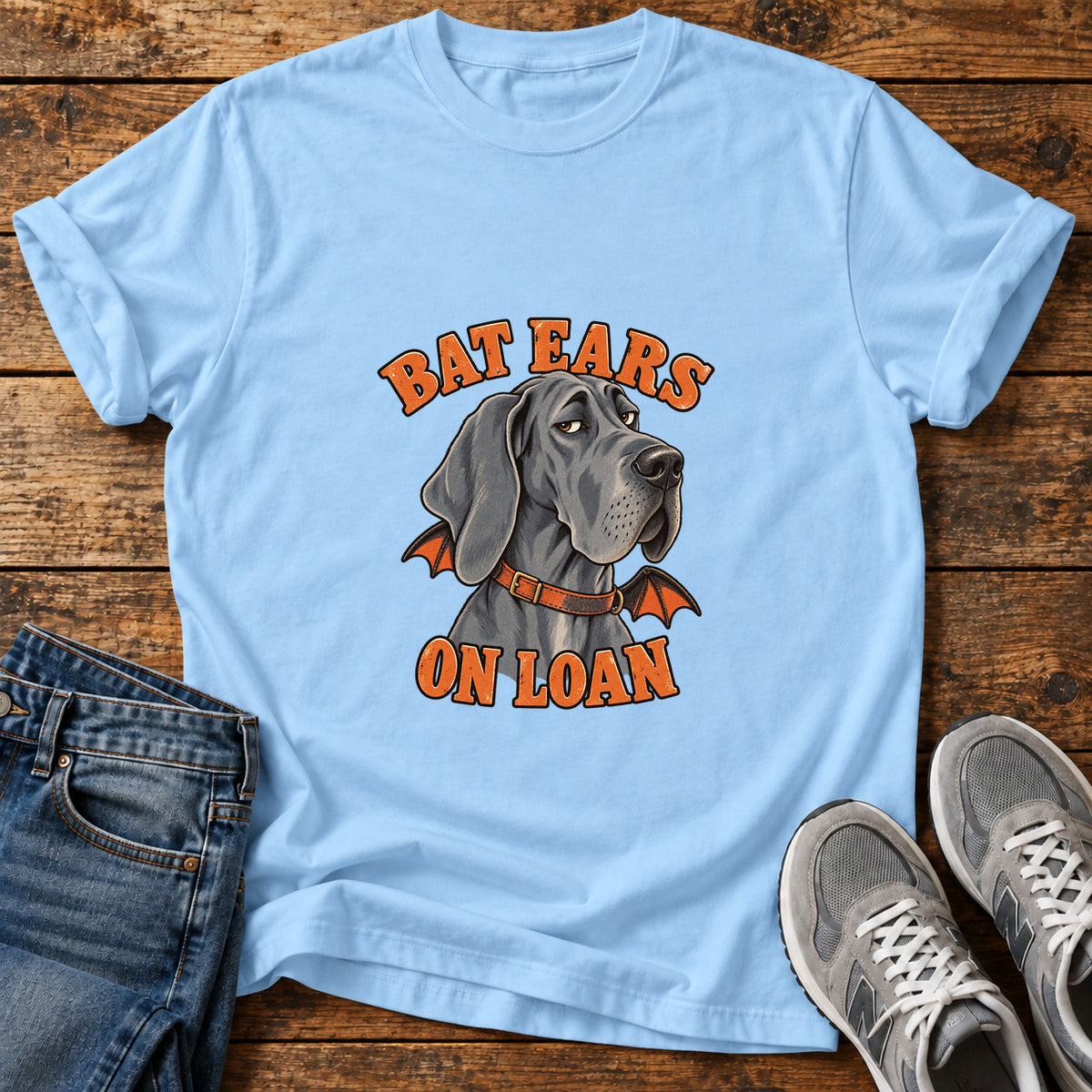 Bat Ears Loan Great Dane graphic T-shirt in Light Blue, shown on a flat-lay shirt mockup