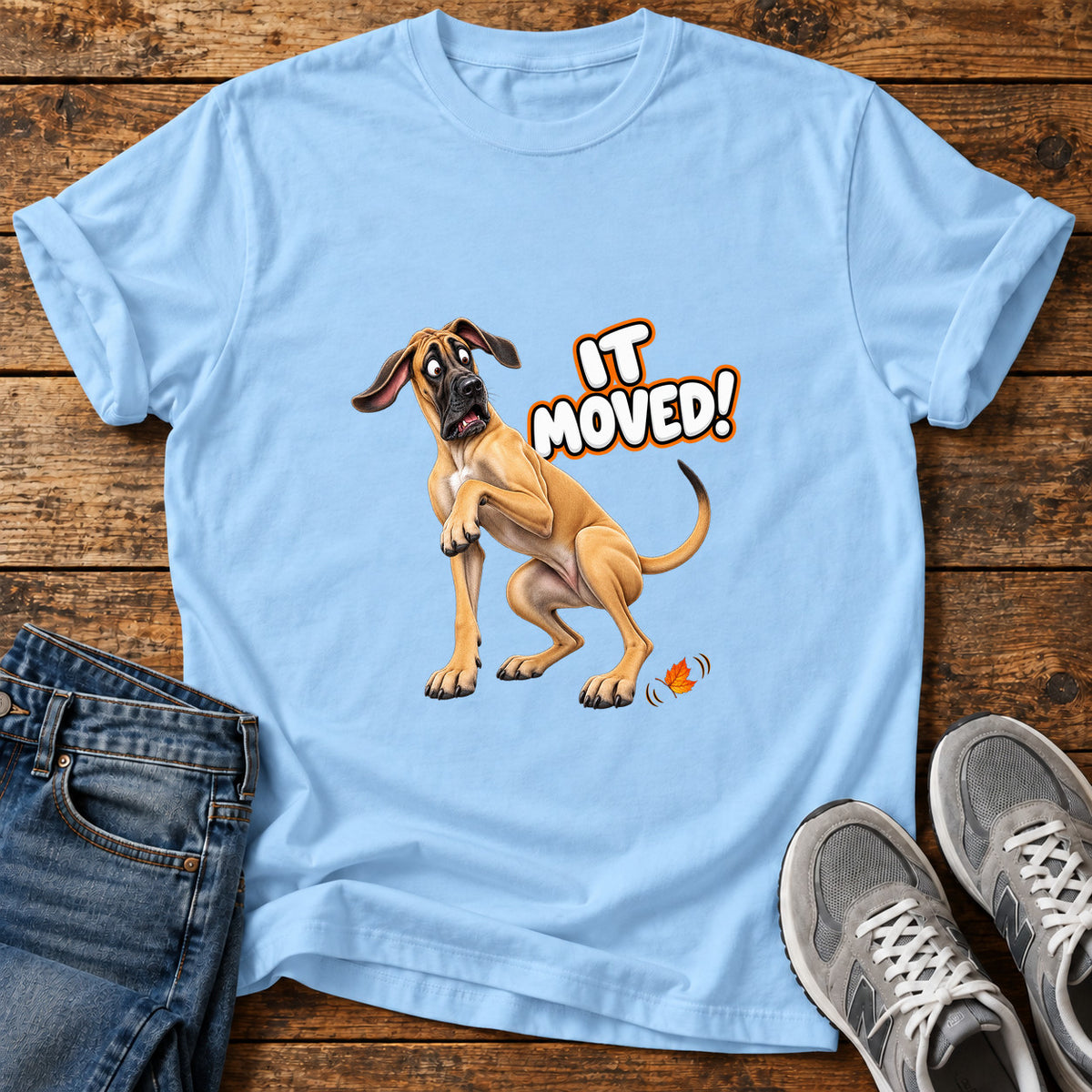 It Moved Great Dane graphic T-shirt in Light Blue, shown on a flat-lay shirt mockup