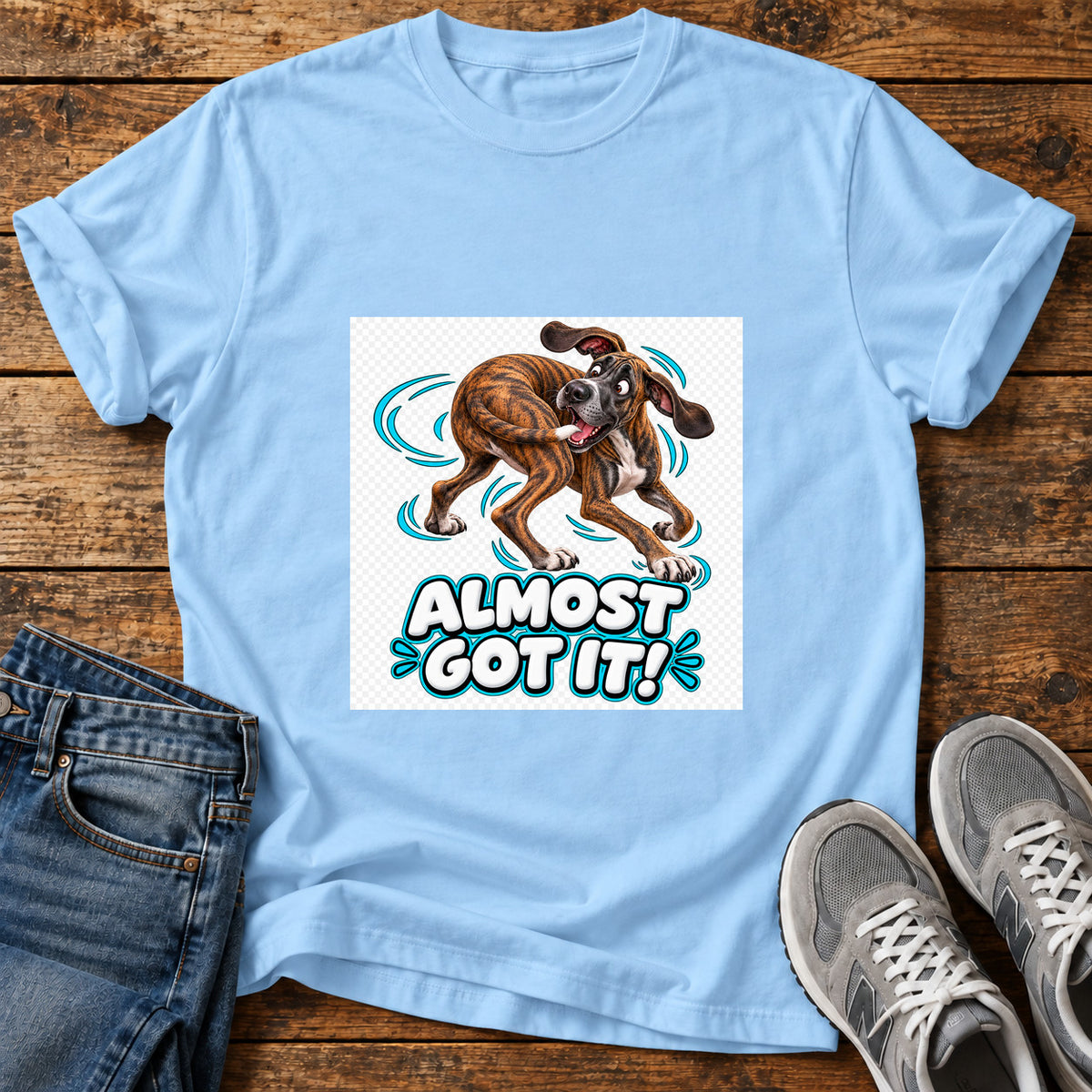 Almost Got It Great Dane graphic T-shirt in Light Blue, shown on a flat-lay shirt mockup