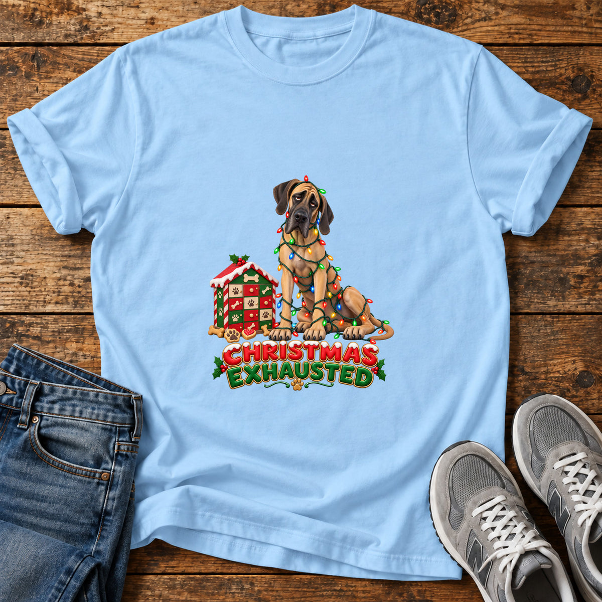 Christmas Exhausted Great Dane graphic T-shirt in Light Blue, shown on a flat-lay shirt mockup