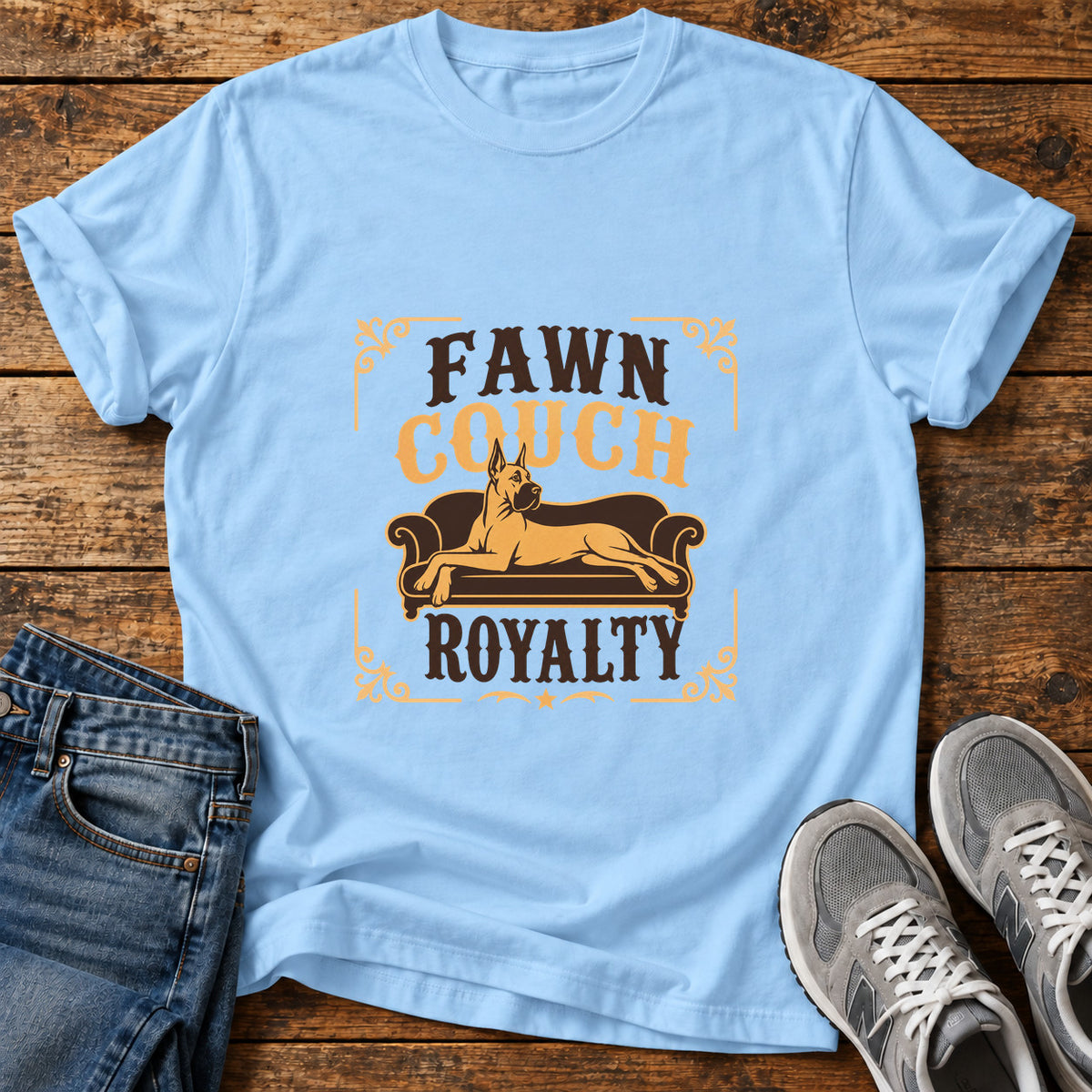 Fawn Couch Royalty Great Dane graphic T-shirt in Light Blue, shown on a flat-lay shirt mockup