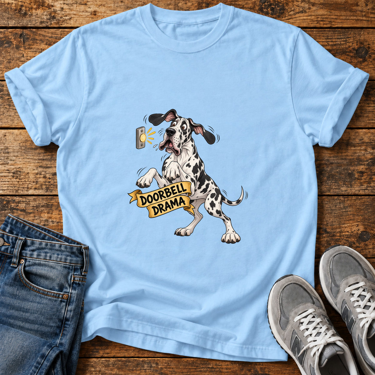 Doorbell Drama Great Dane graphic T-shirt in Light Blue, shown on a flat-lay shirt mockup