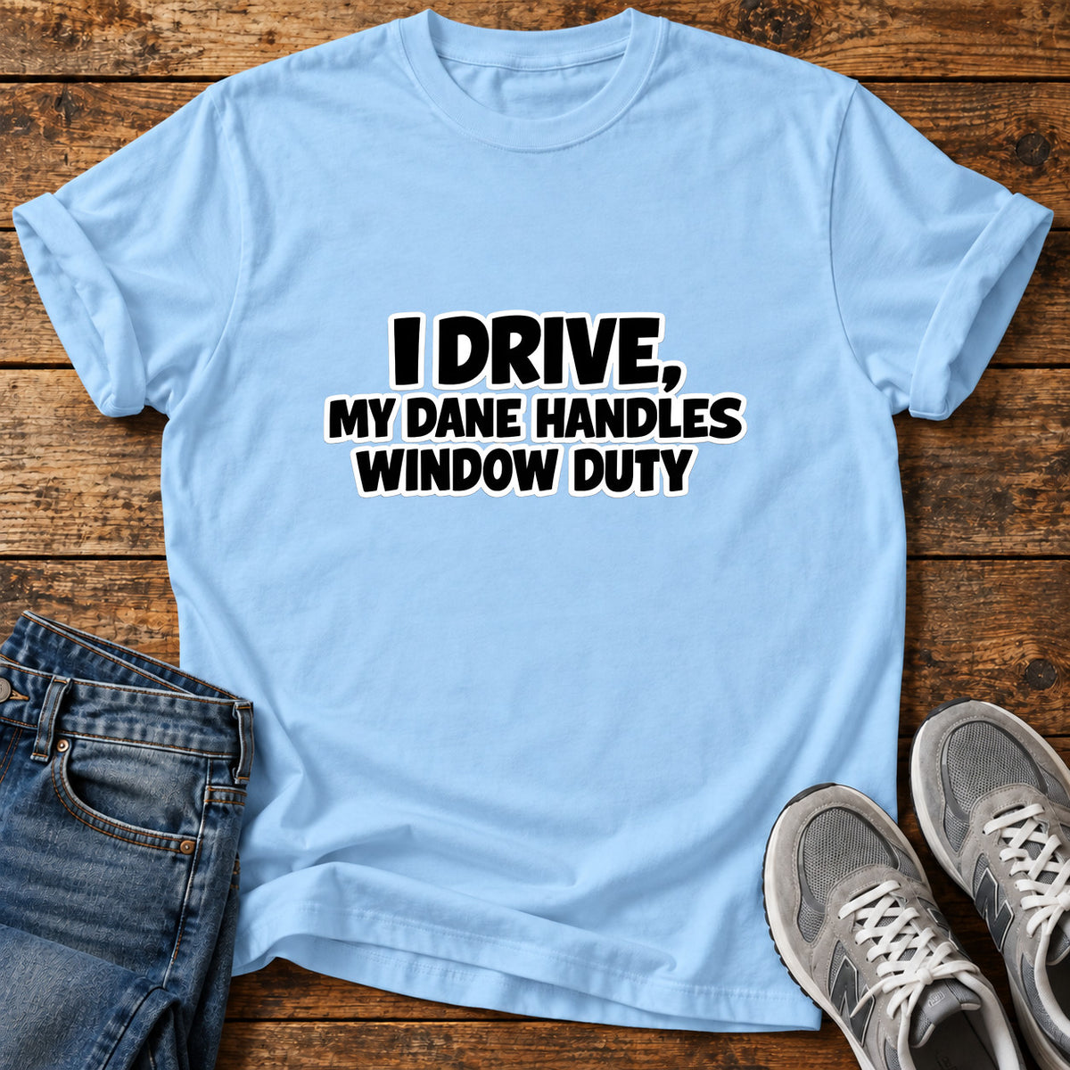 Dane Window Duty Great Dane graphic T-shirt in Light Blue, shown on a flat-lay shirt mockup