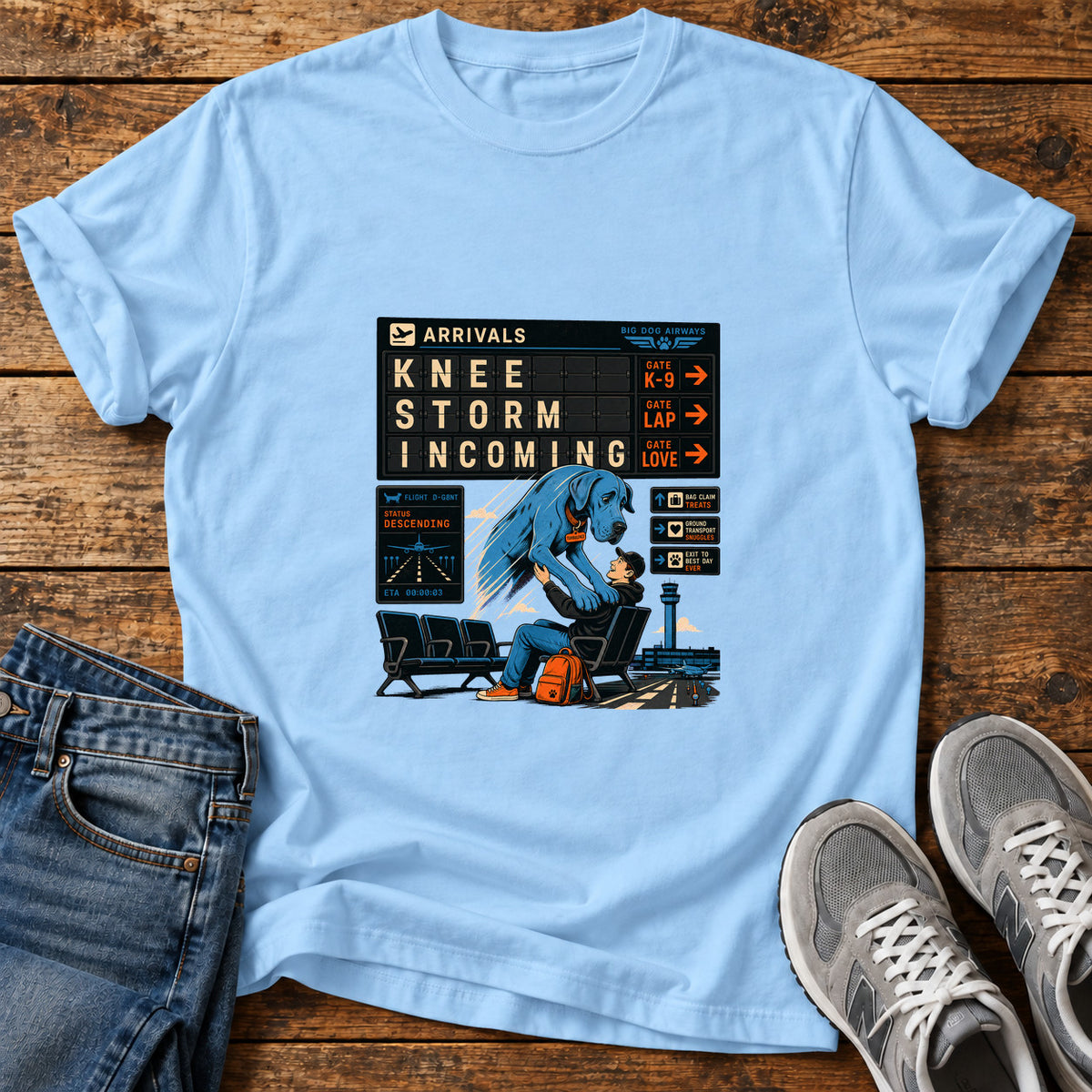 Knee Storm Incoming Great Dane graphic T-shirt in Light Blue, shown on a flat-lay shirt mockup