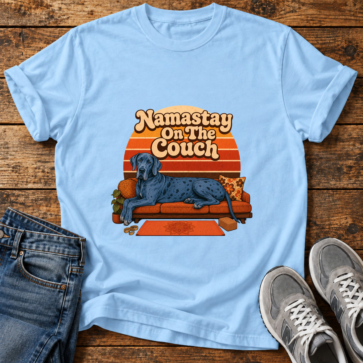 Namastay Couch Pooch Great Dane graphic T-shirt in Light Blue, shown on a flat-lay shirt mockup