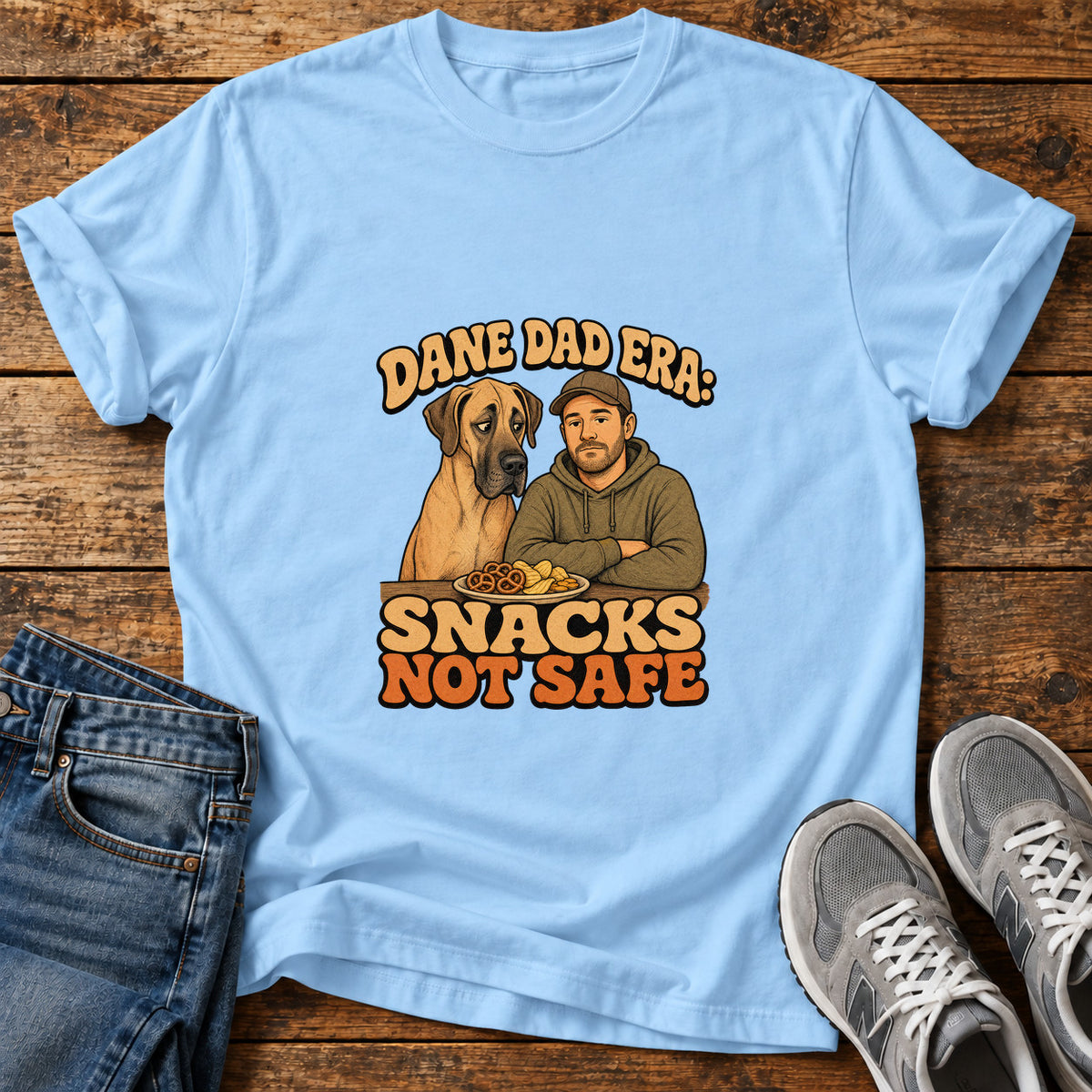 Snacks Not Safe Great Dane graphic T-shirt in Light Blue, shown on a flat-lay shirt mockup