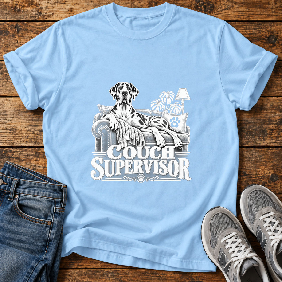 Couch Supervisor Great Dane graphic T-shirt in Light Blue, shown on a flat-lay shirt mockup