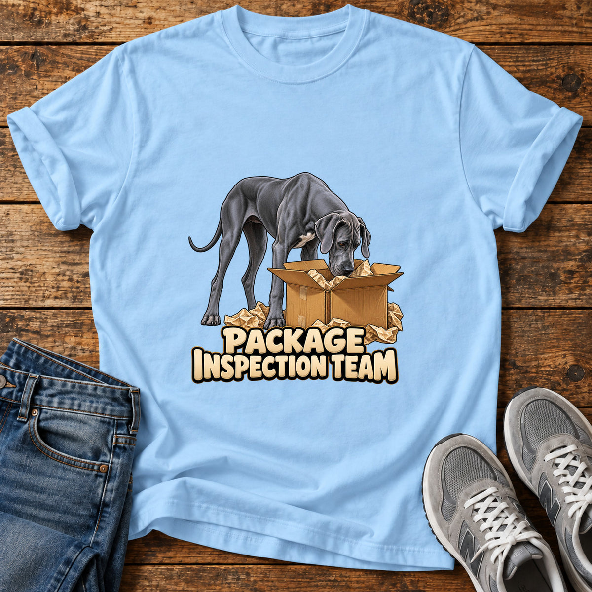Package Dog Patrol Great Dane graphic T-shirt in Light Blue, shown on a flat-lay shirt mockup