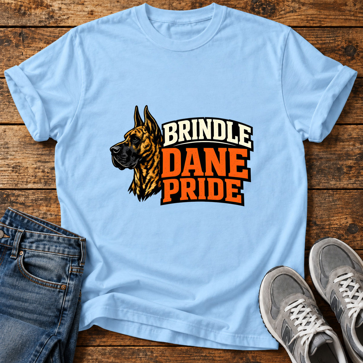 Brindle Dane Pride Great Dane graphic T-shirt in Light Blue, shown on a flat-lay shirt mockup