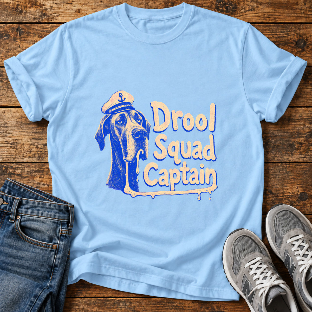 Drool Squad Captain Great Dane graphic T-shirt in Light Blue, shown on a flat-lay shirt mockup