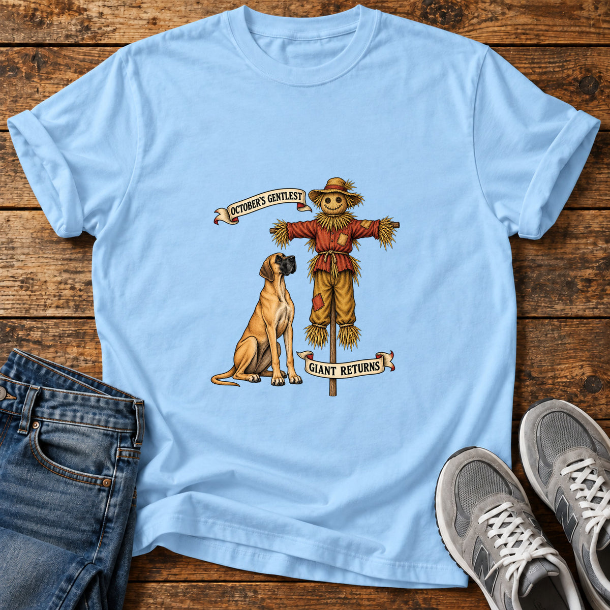 October's Gentlest Great Dane graphic T-shirt in Light Blue, shown on a flat-lay shirt mockup