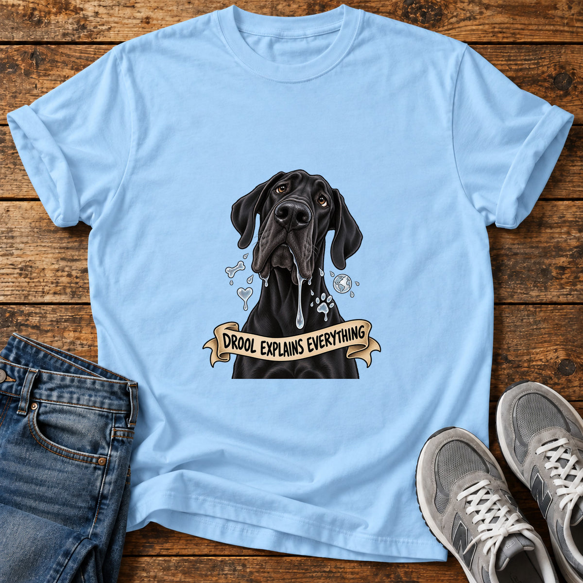 Drool Explains Everything Great Dane graphic T-shirt in Light Blue, shown on a flat-lay shirt mockup
