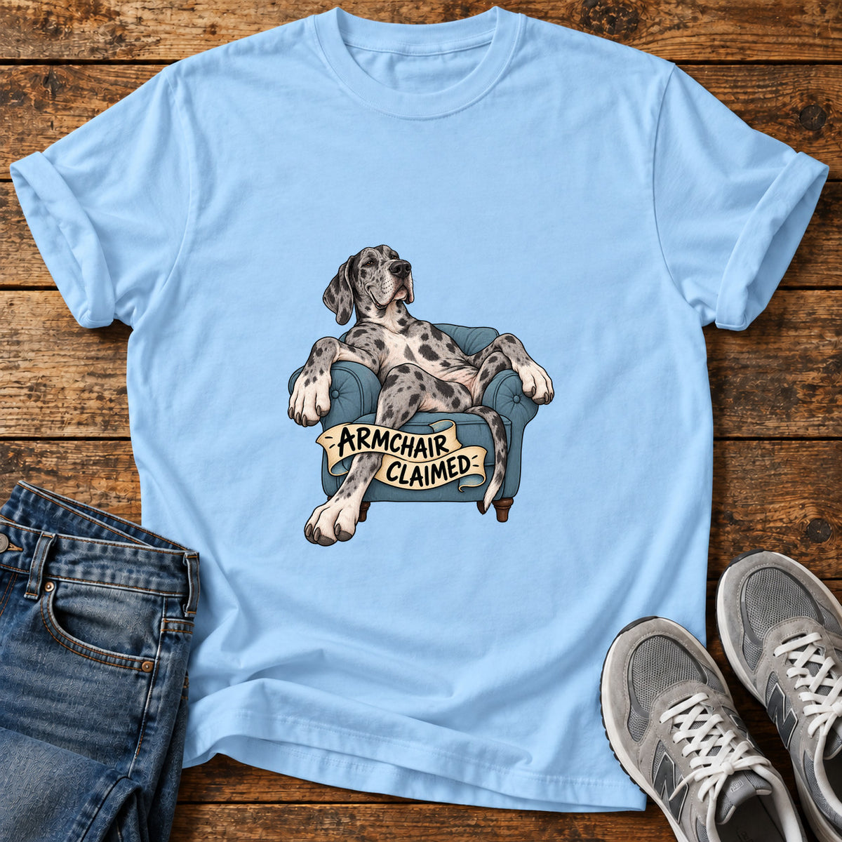 Armchair Claimed Great Dane graphic T-shirt in Light Blue, shown on a flat-lay shirt mockup