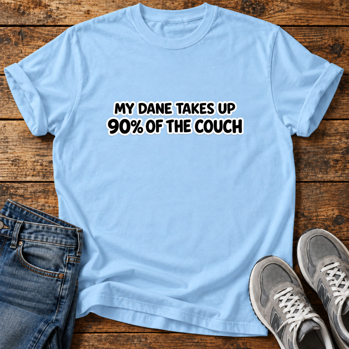 Dane Couch Hog Great Dane graphic T-shirt in Light Blue, shown on a flat-lay shirt mockup