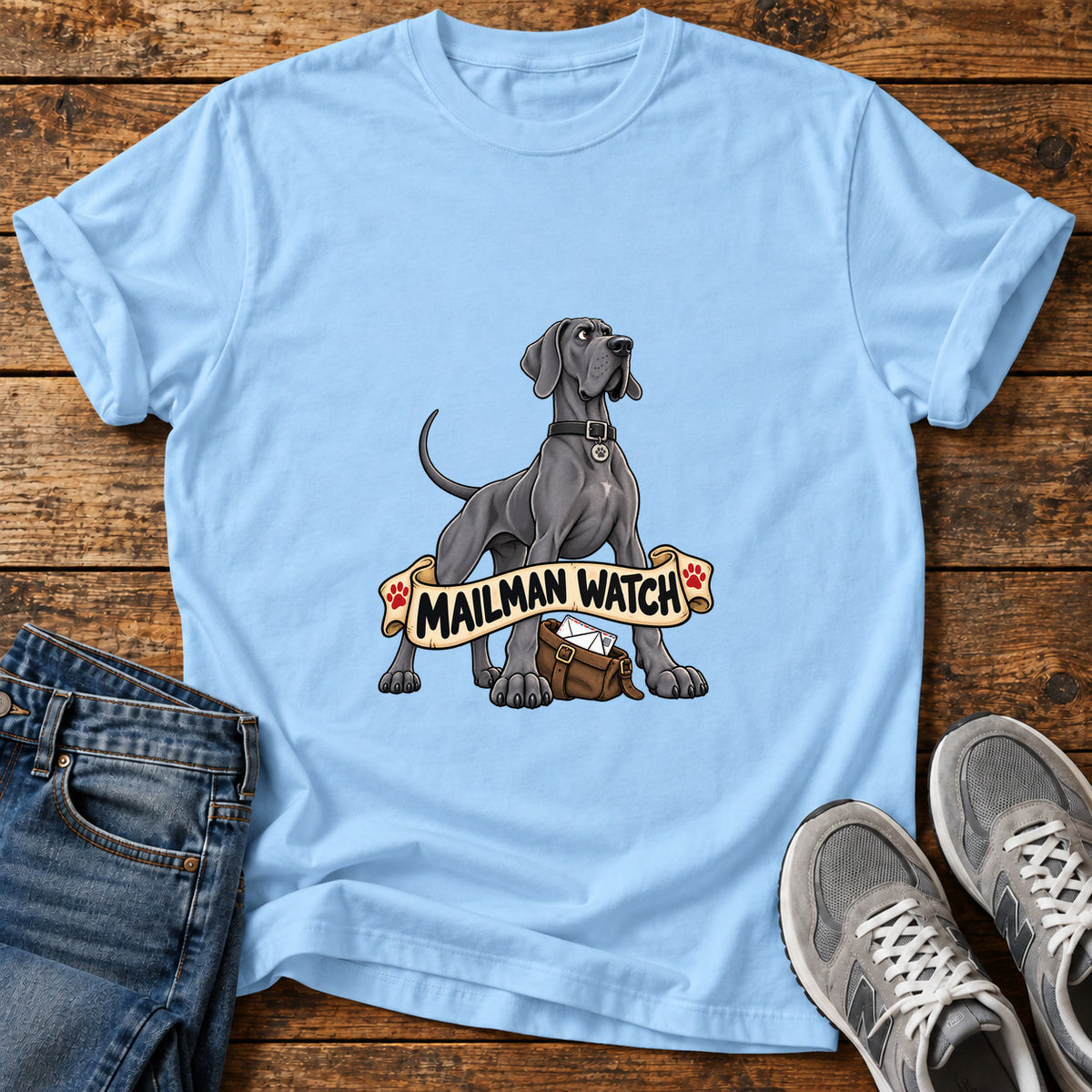 Mailman Watch Great Dane graphic T-shirt in Light Blue, shown on a flat-lay shirt mockup
