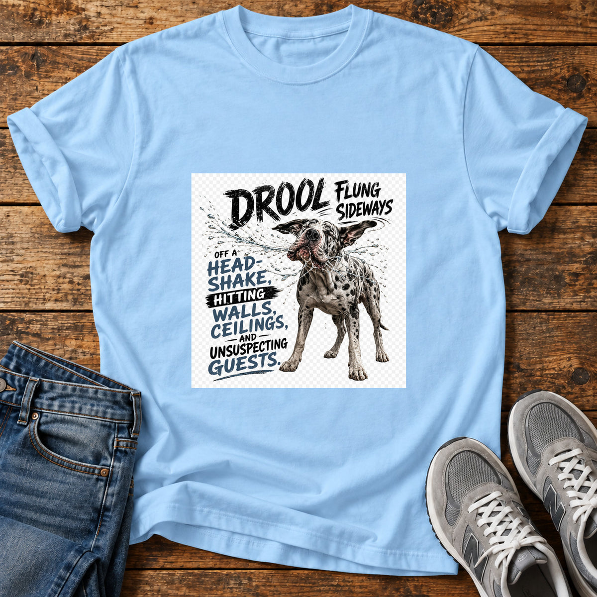 Drool Flung Sideways Great Dane graphic T-shirt in Light Blue, shown on a flat-lay shirt mockup