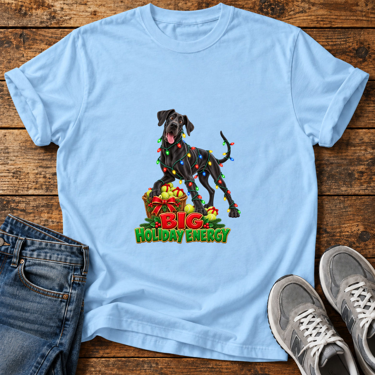 Big Holiday Energy Great Dane graphic T-shirt in Light Blue, shown on a flat-lay shirt mockup