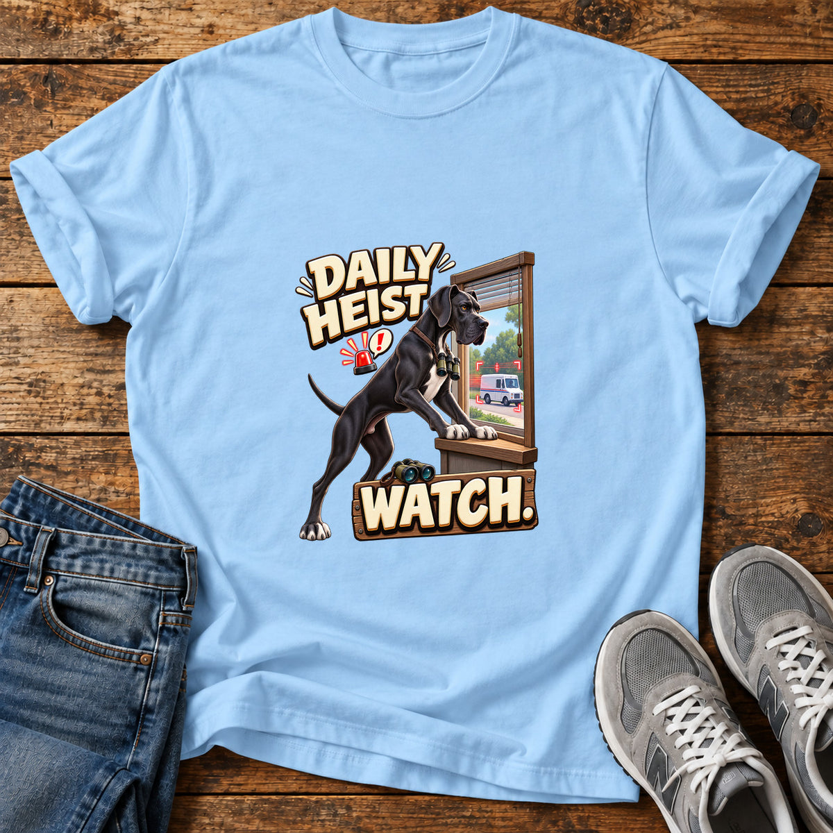 Daily Heist Watch Great Dane graphic T-shirt in Light Blue, shown on a flat-lay shirt mockup