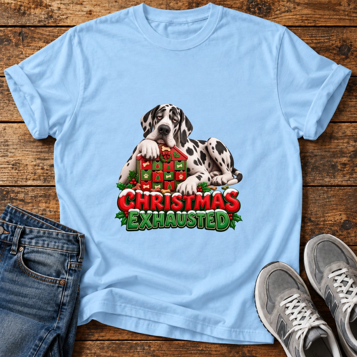 Christmas Exhausted Great Dane graphic T-shirt in Light Blue, shown on a flat-lay shirt mockup